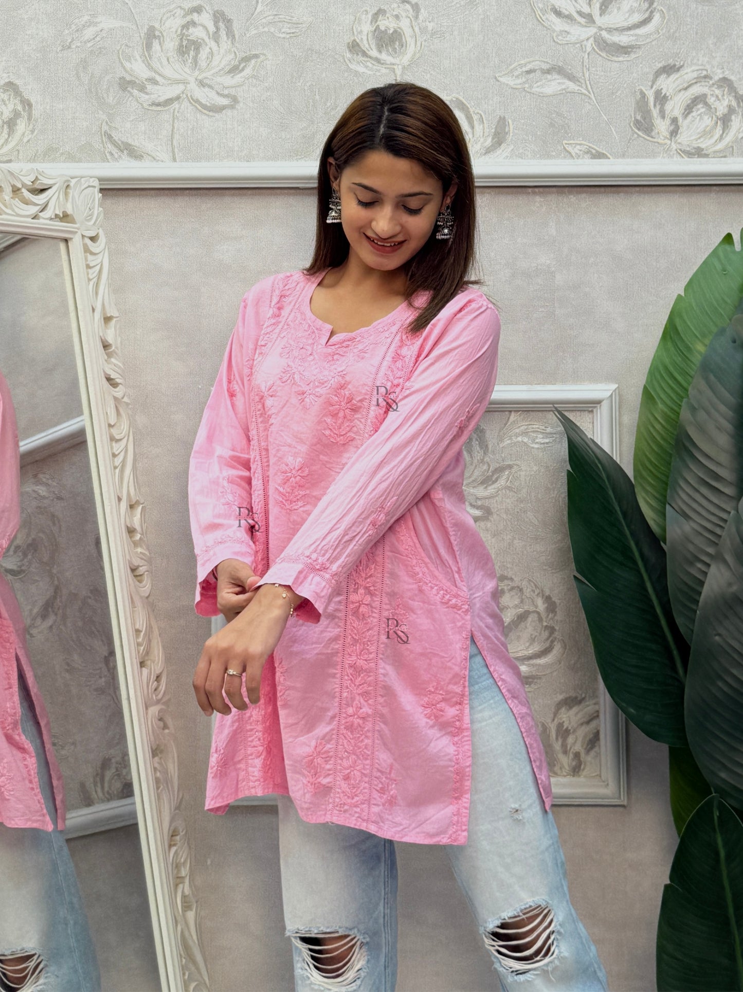 Pink cotton chikankari short kurta with hand embroidery and pockets.