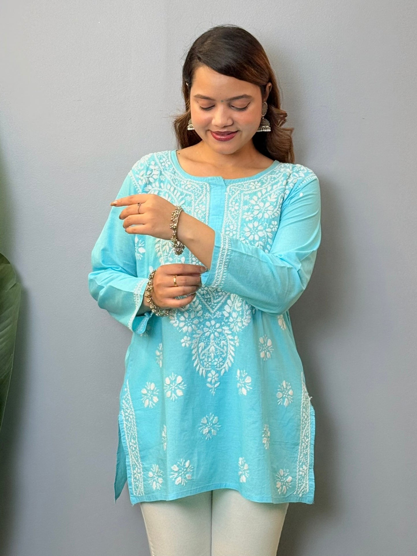 Sky blue cotton short chikankari kurta with white hand embroidery, styled for casual wear