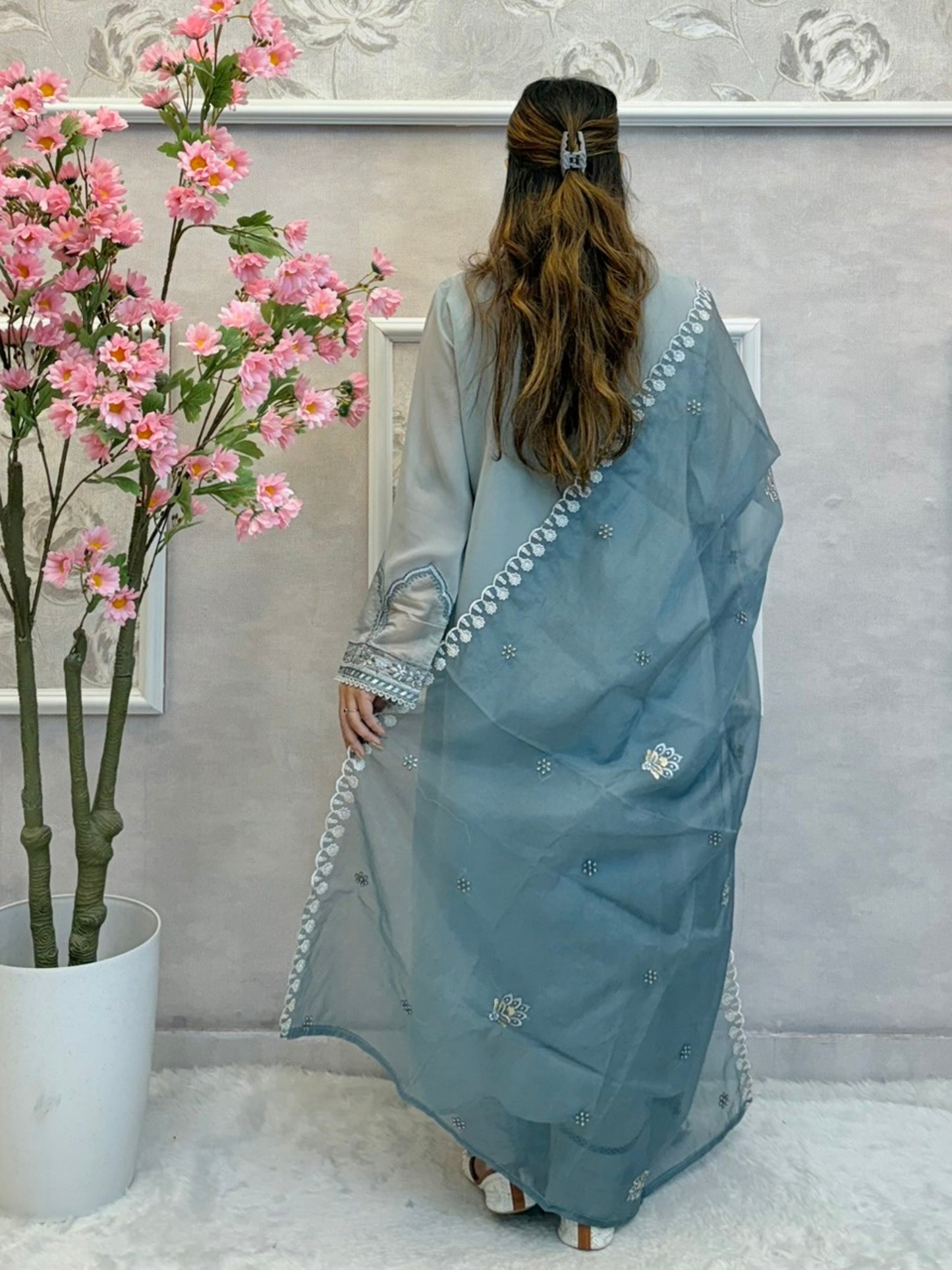Model wearing dusty blue chikankari designer suit with organza dupatta