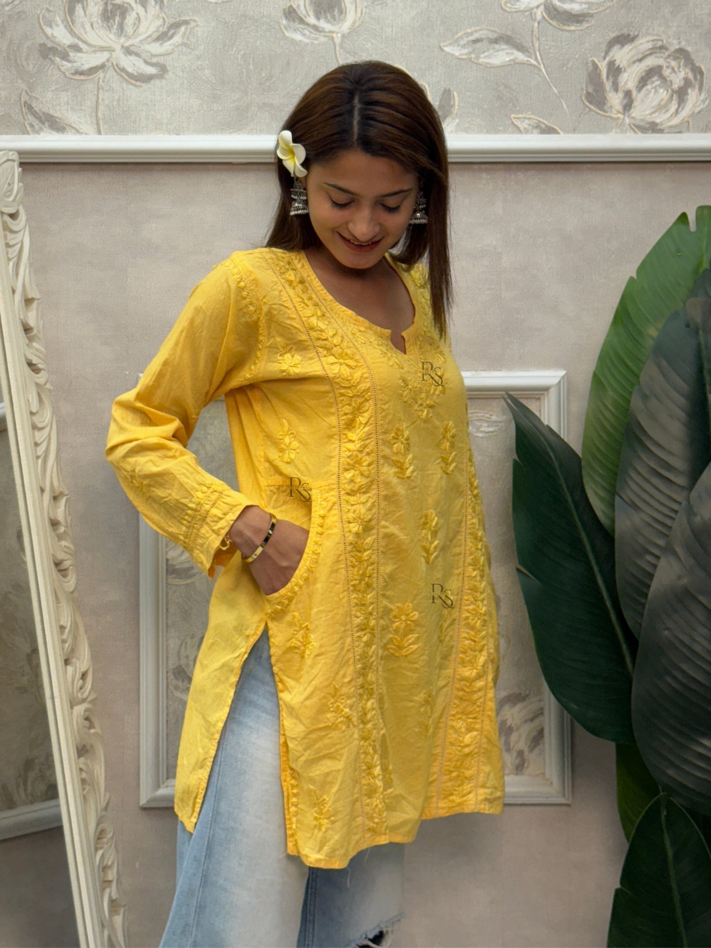 Yellow cotton short chikankari kurta with hand embroidery and side pockets.