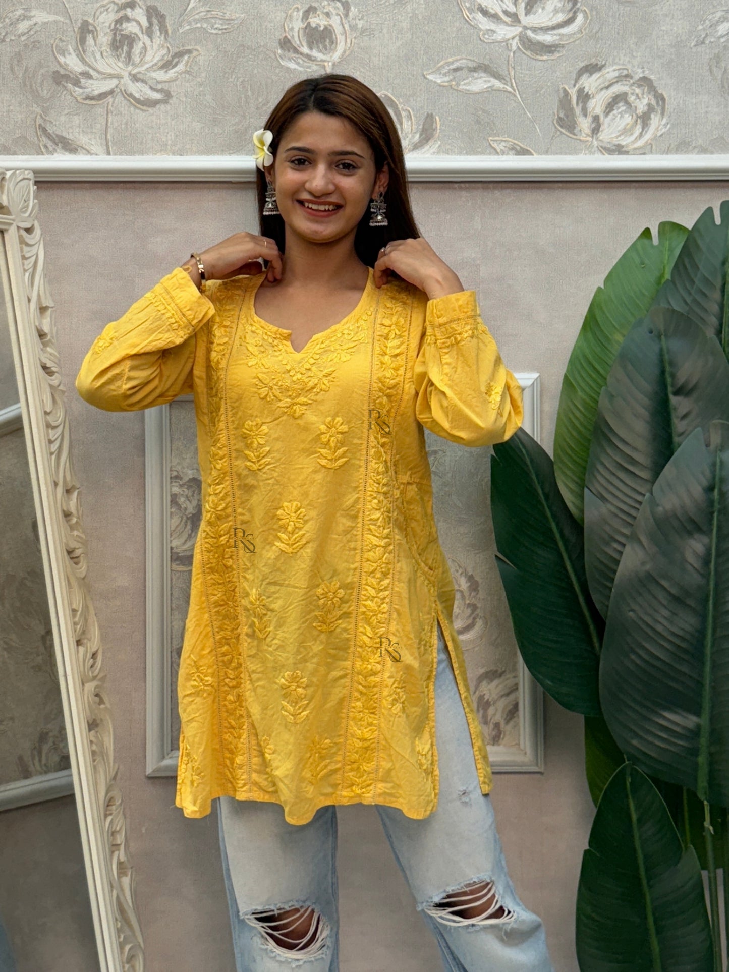 Yellow cotton short chikankari kurta with hand embroidery and side pockets.