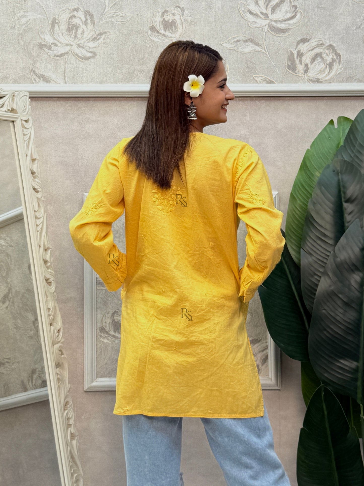 Yellow cotton short chikankari kurta with hand embroidery and side pockets.