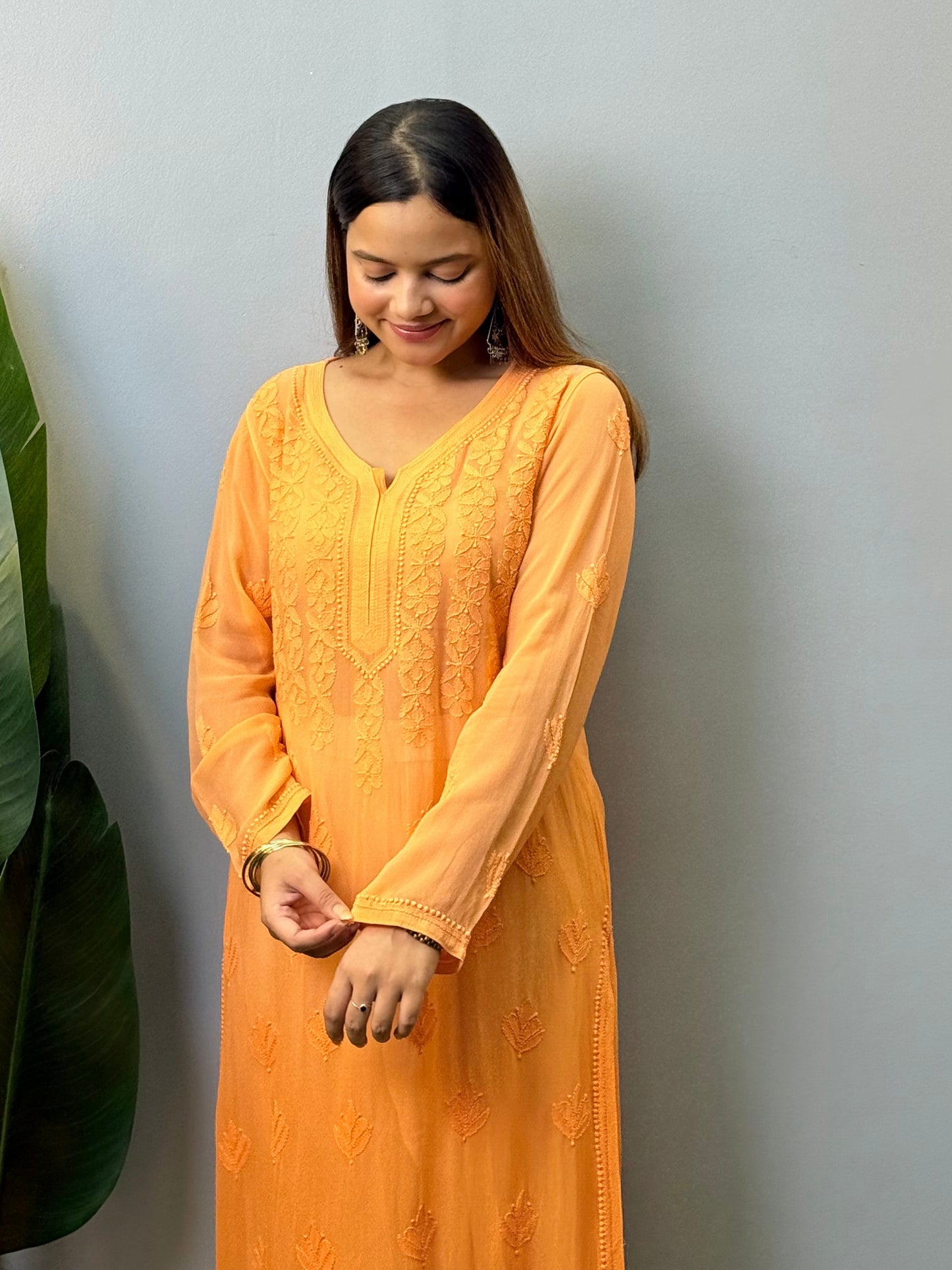 Orange viscose Lucknow Chikankari kurta with intricate hand embroidery, elegant and comfortable ethnic wear.