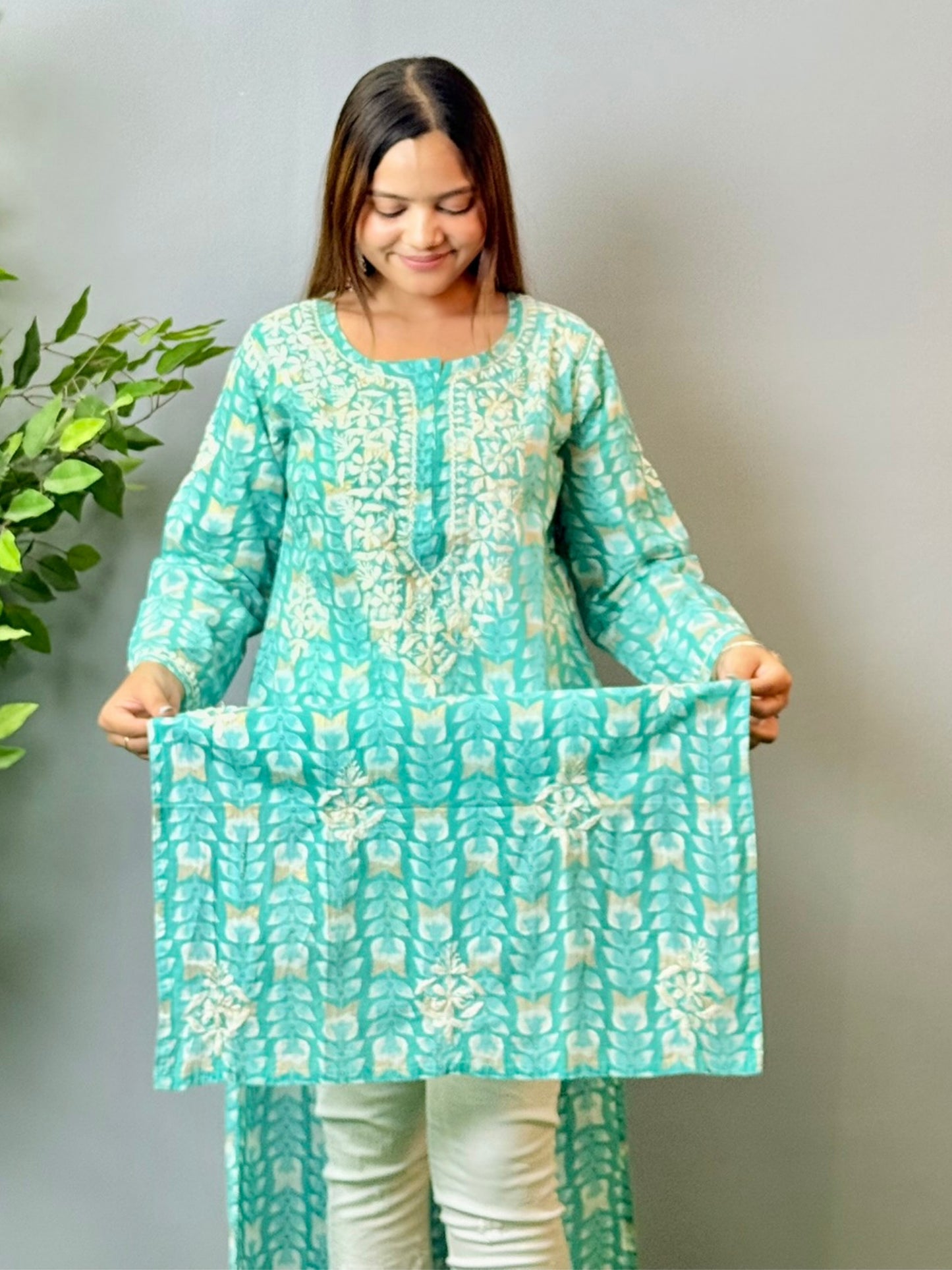 Model wearing an aqua blue printed chikankari mulmul kurta with white embroidery detailing