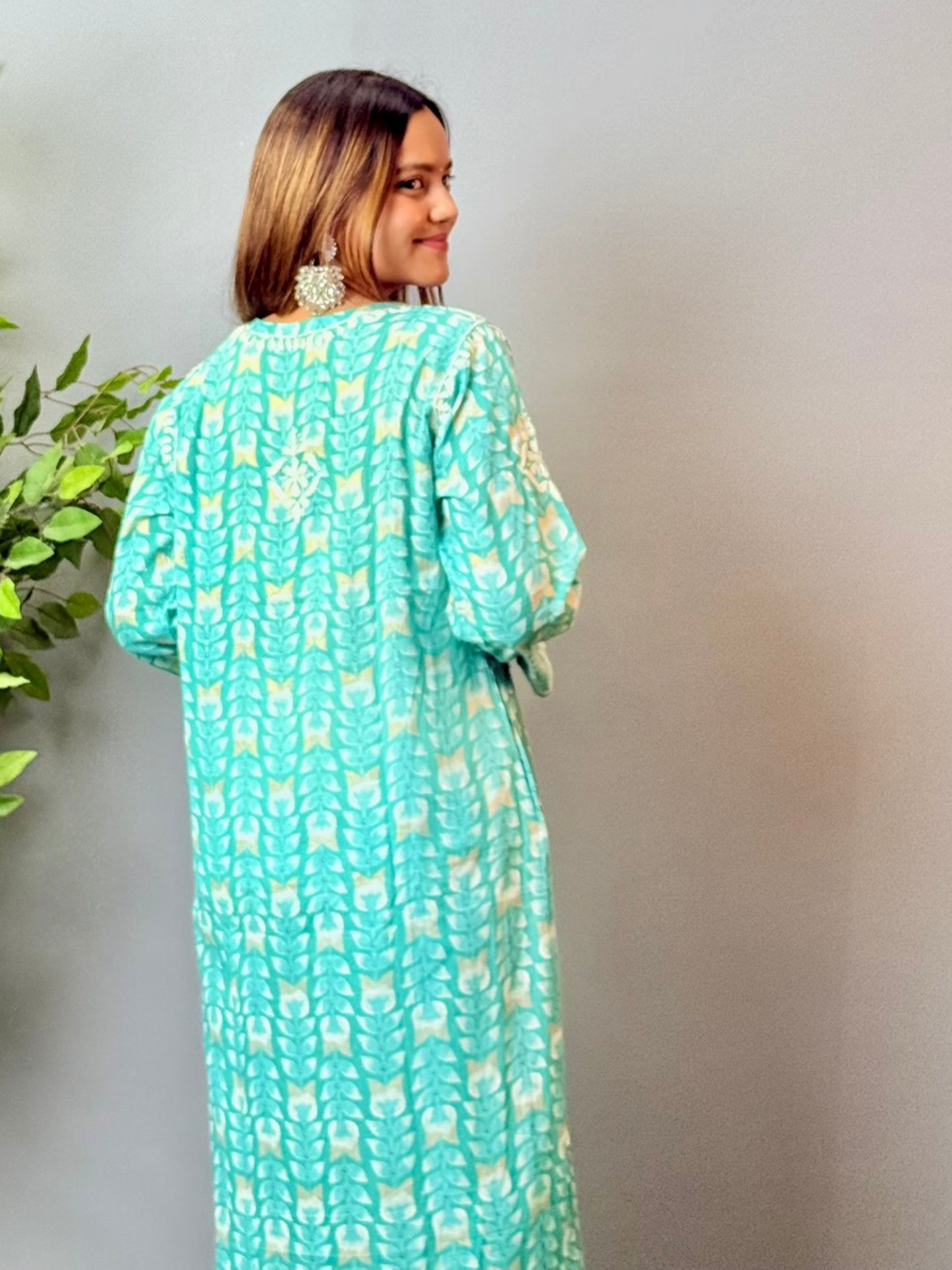Model wearing an aqua blue printed chikankari mulmul kurta with white embroidery detailing