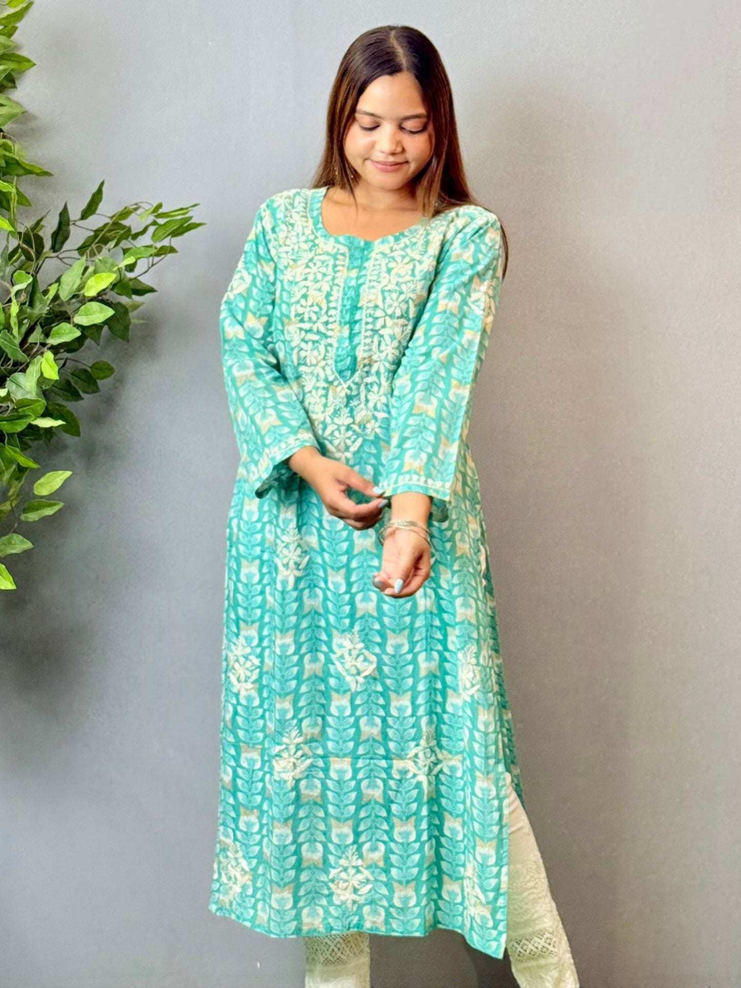 Model wearing an aqua blue printed chikankari mulmul kurta with white embroidery detailing