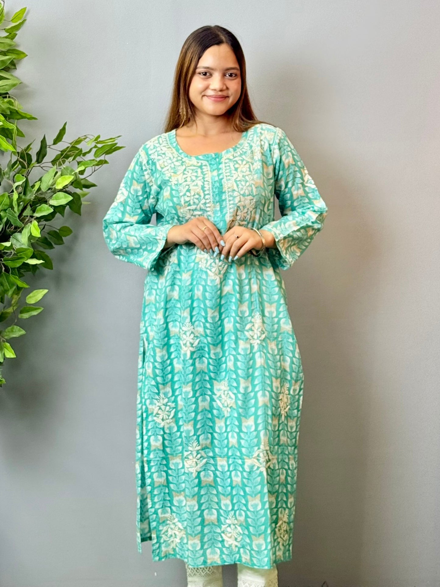 Model wearing an aqua blue printed chikankari mulmul kurta with white embroidery detailing
