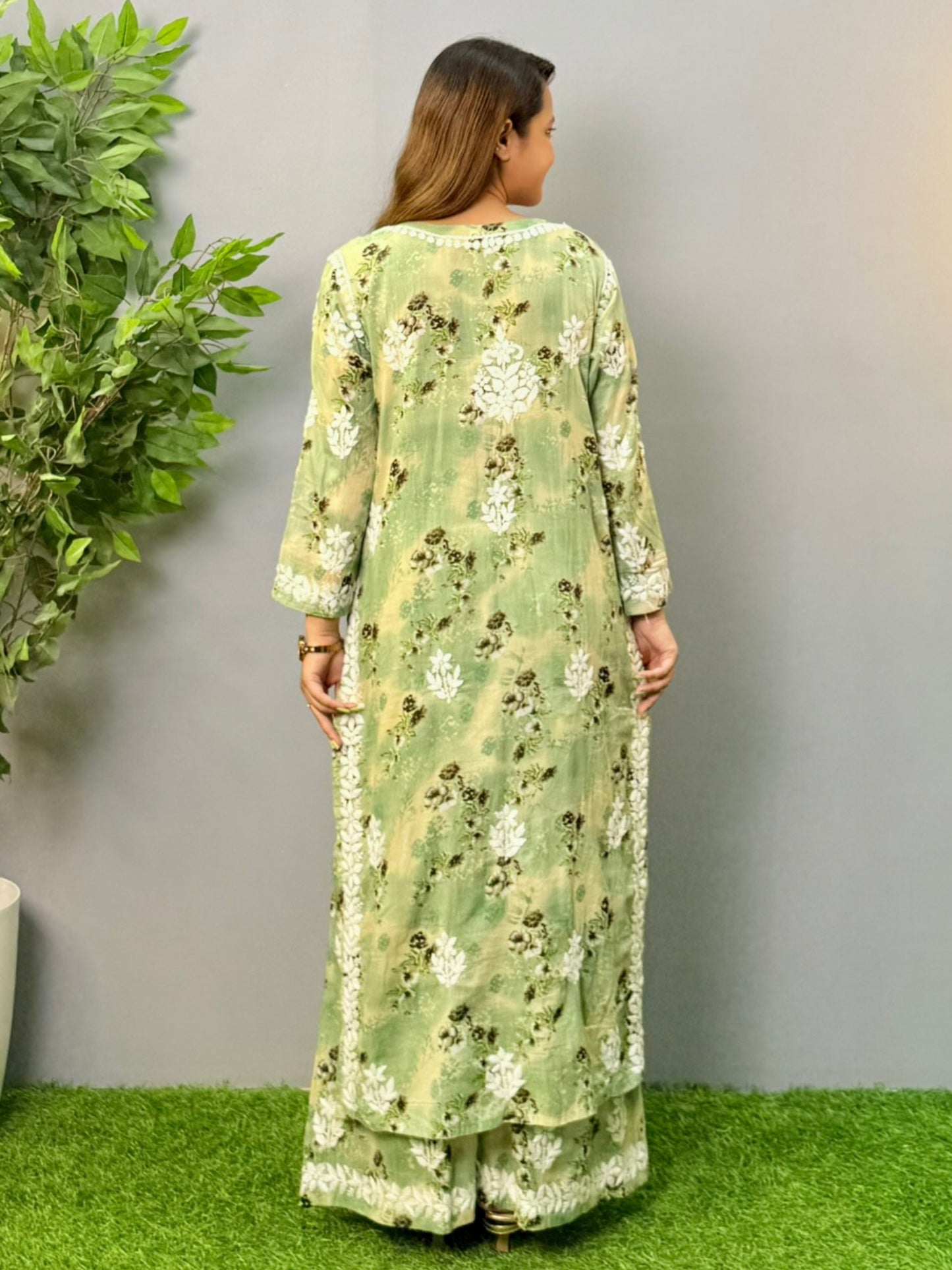 Model wearing olive floral printed mulmul chikankari kurta and palazzo set with white hand embroidery