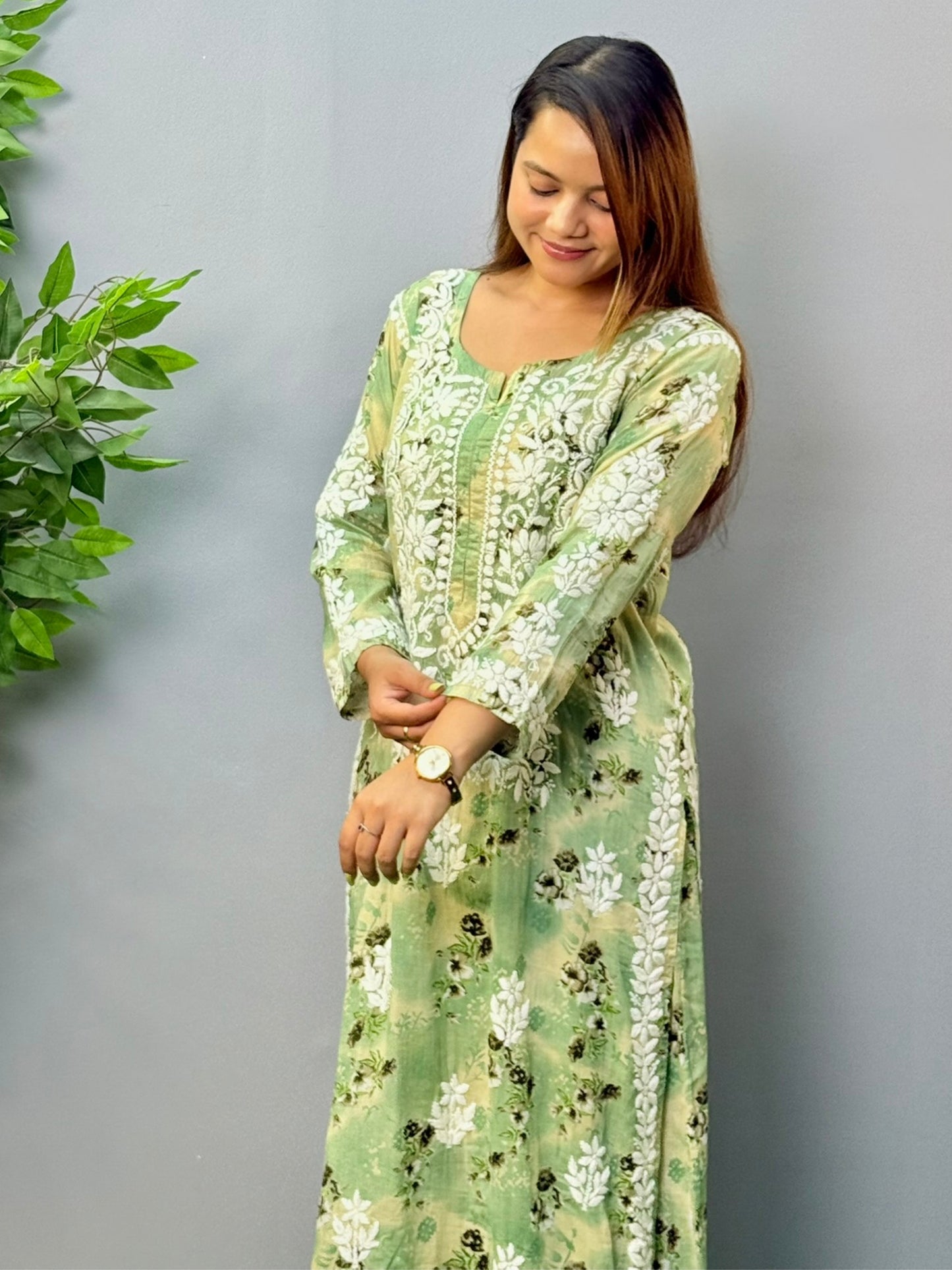 Model wearing olive floral printed mulmul chikankari kurta and palazzo set with white hand embroidery