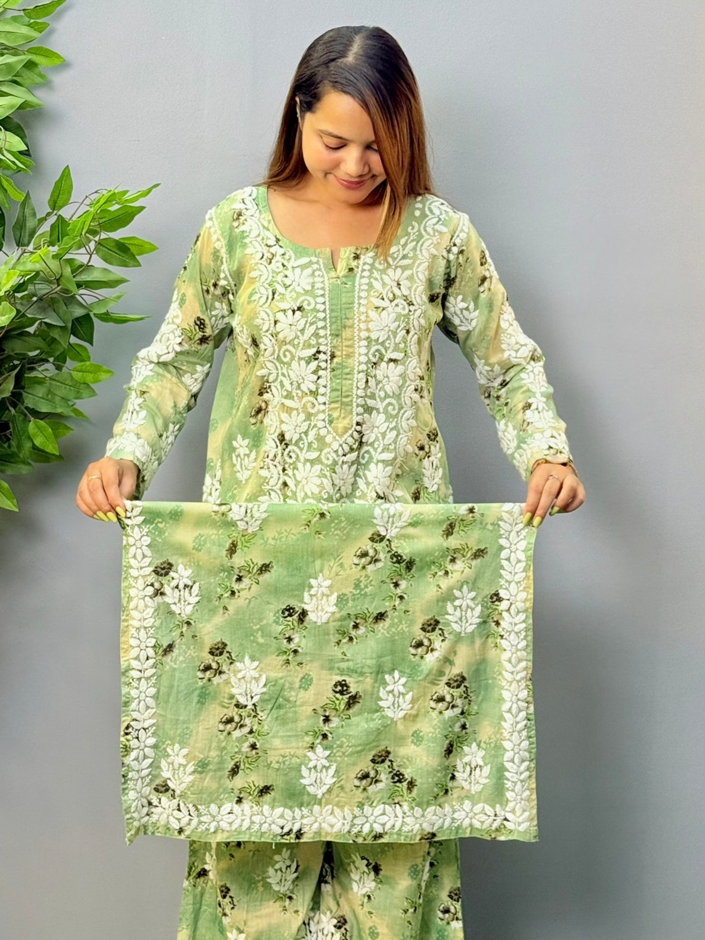 Model wearing olive floral printed mulmul chikankari kurta and palazzo set with white hand embroidery