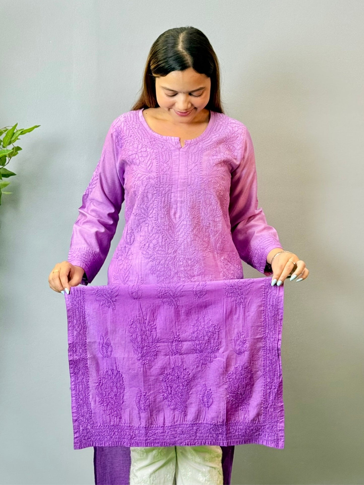 Model wearing a purple Chanderi Lucknowi chikankari kurta with subtle embroidery, styled with white palazzo pants.