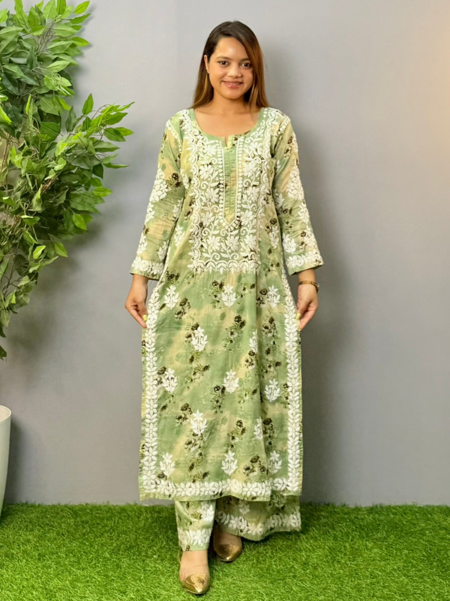Model wearing olive floral printed mulmul chikankari kurta and palazzo set with white hand embroidery