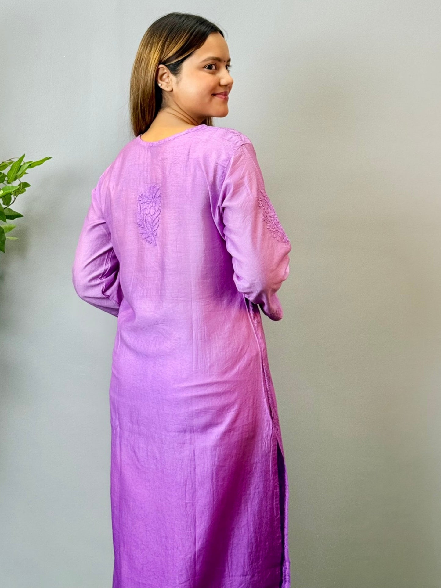 Model wearing a purple Chanderi Lucknowi chikankari kurta with subtle embroidery, styled with white palazzo pants.