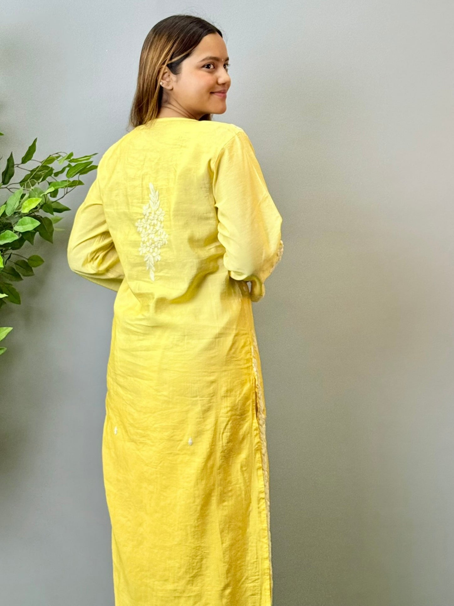 Model wearing a yellow ombre chanderi chikankari kurta with intricate 3D hand embroidery