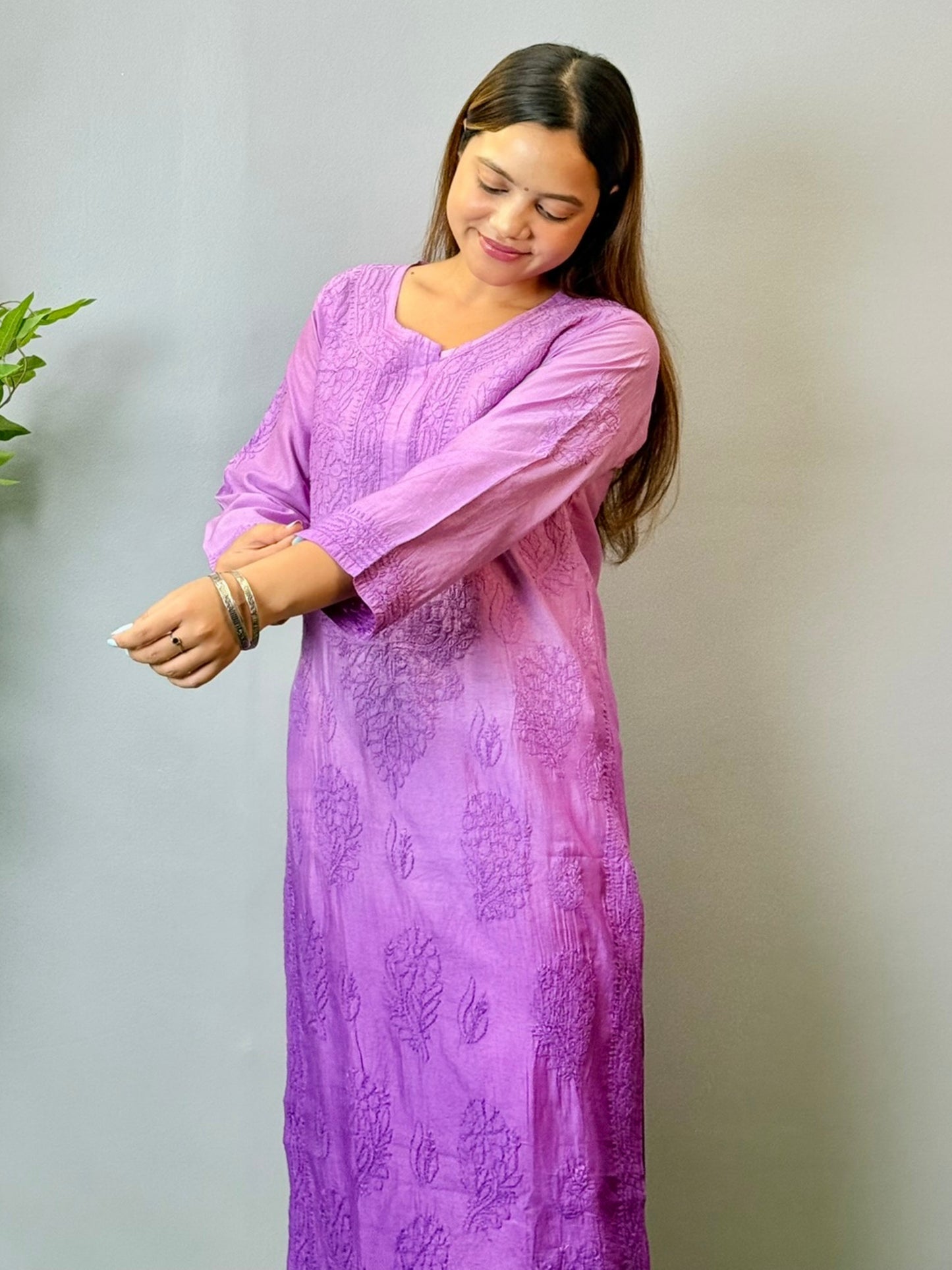Model wearing a purple Chanderi Lucknowi chikankari kurta with subtle embroidery, styled with white palazzo pants.