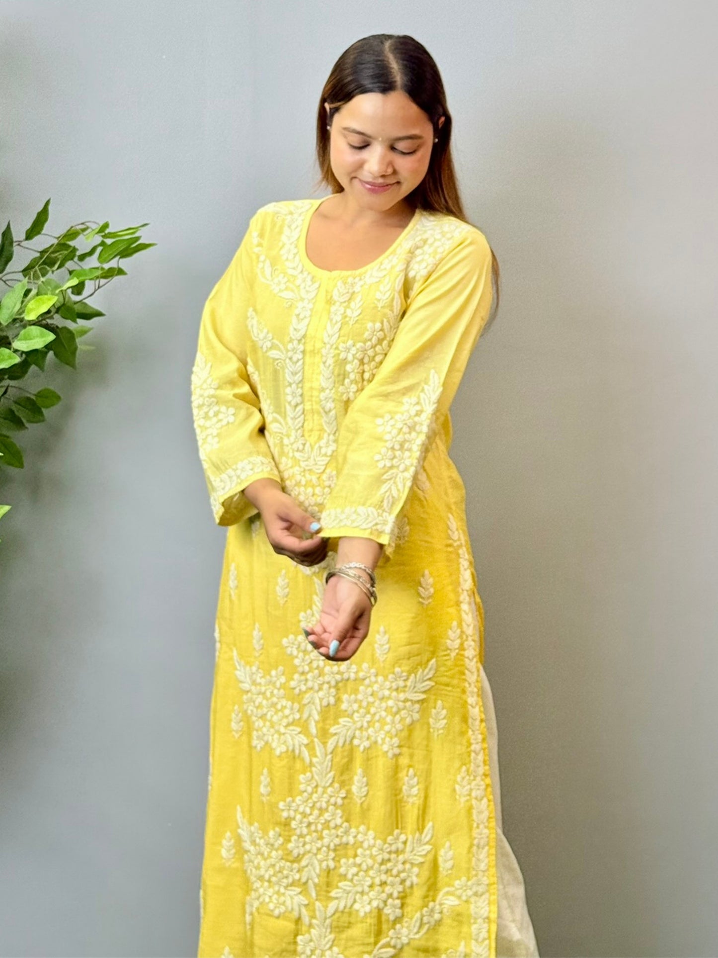 Model wearing a yellow ombre chanderi chikankari kurta with intricate 3D hand embroidery