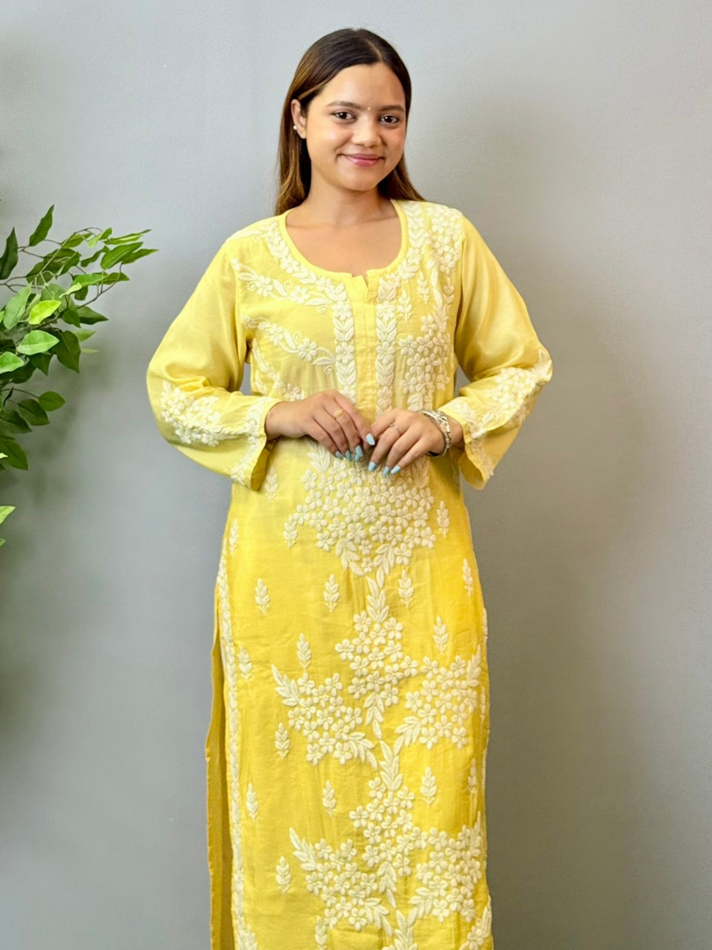 Model wearing a yellow ombre chanderi chikankari kurta with intricate 3D hand embroidery