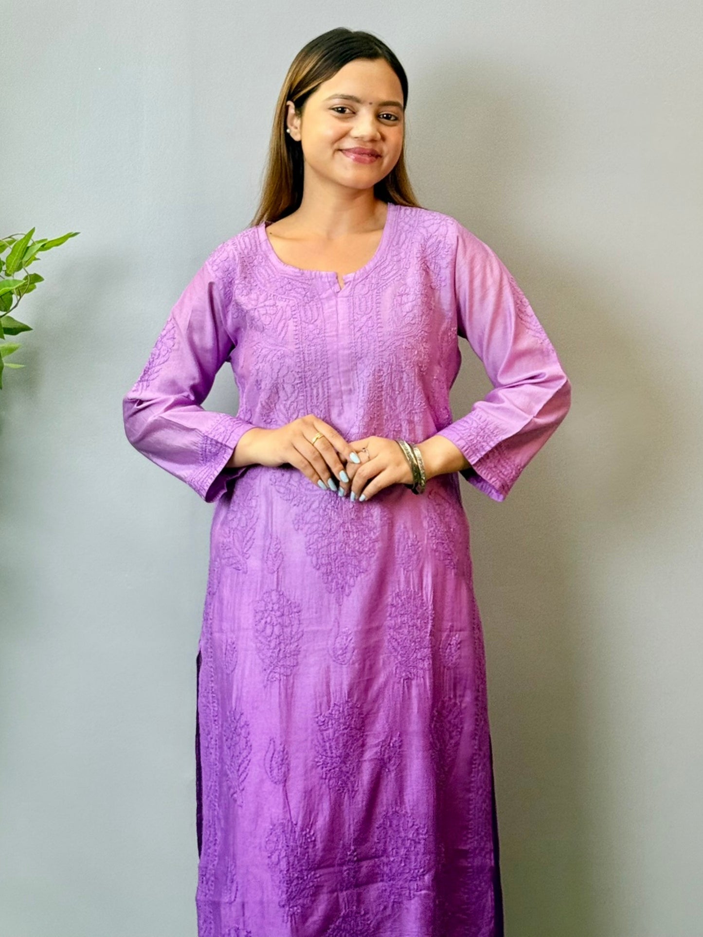 Model wearing a purple Chanderi Lucknowi chikankari kurta with subtle embroidery, styled with white palazzo pants.