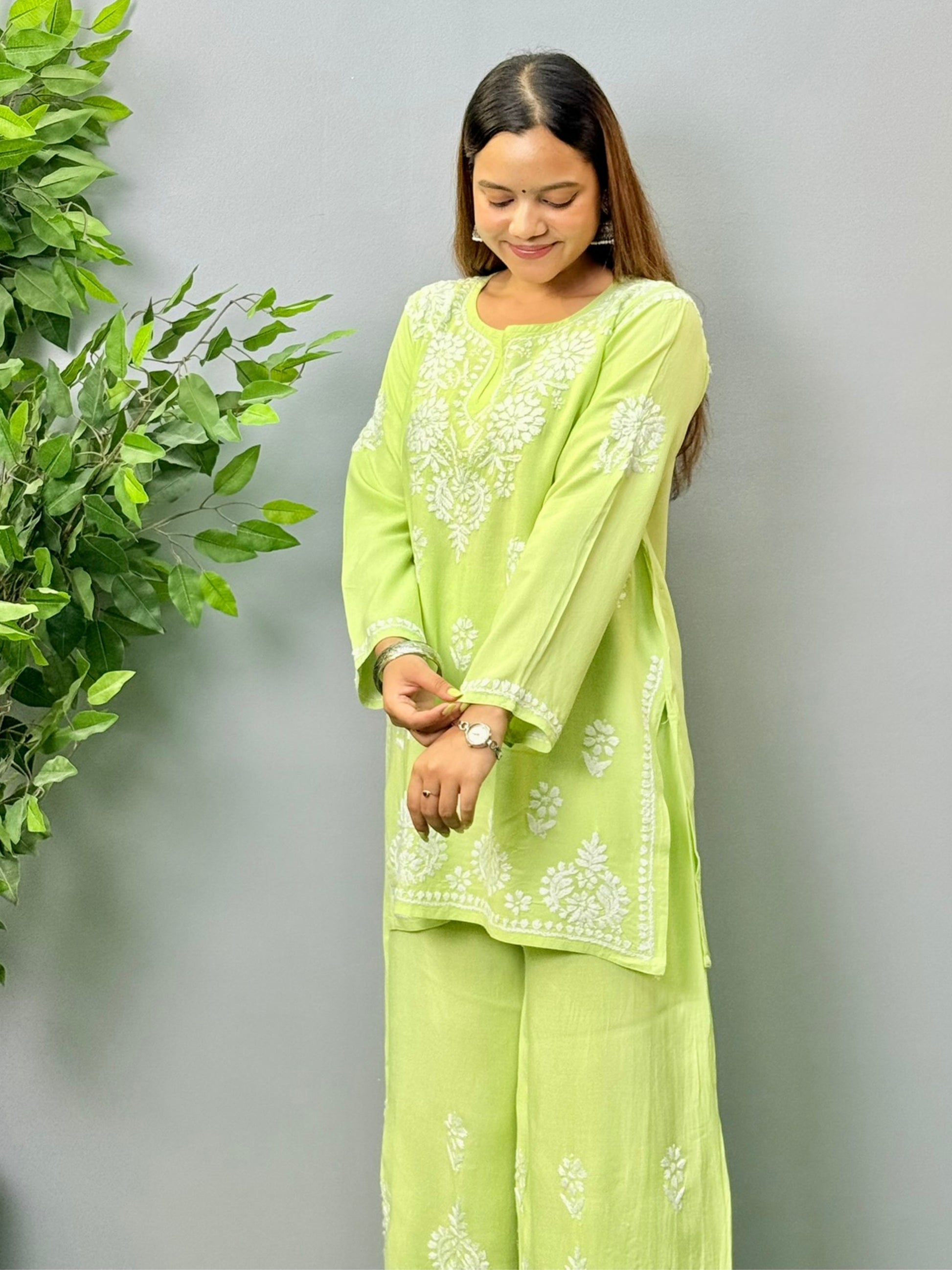 Model wearing pista green rayon short Chikankari kurta and palazzo set with white embroidery