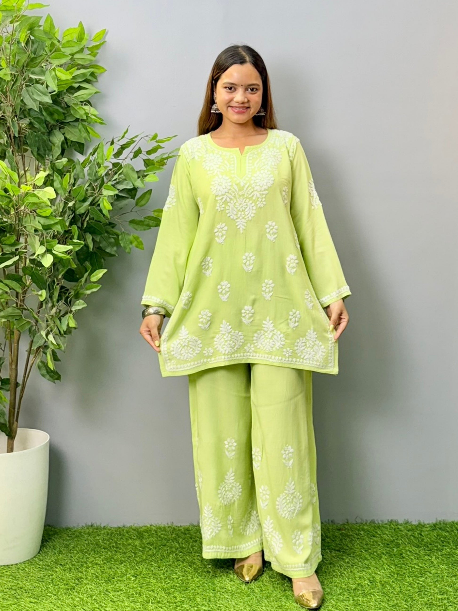 Model wearing pista green rayon short Chikankari kurta and palazzo set with white embroidery