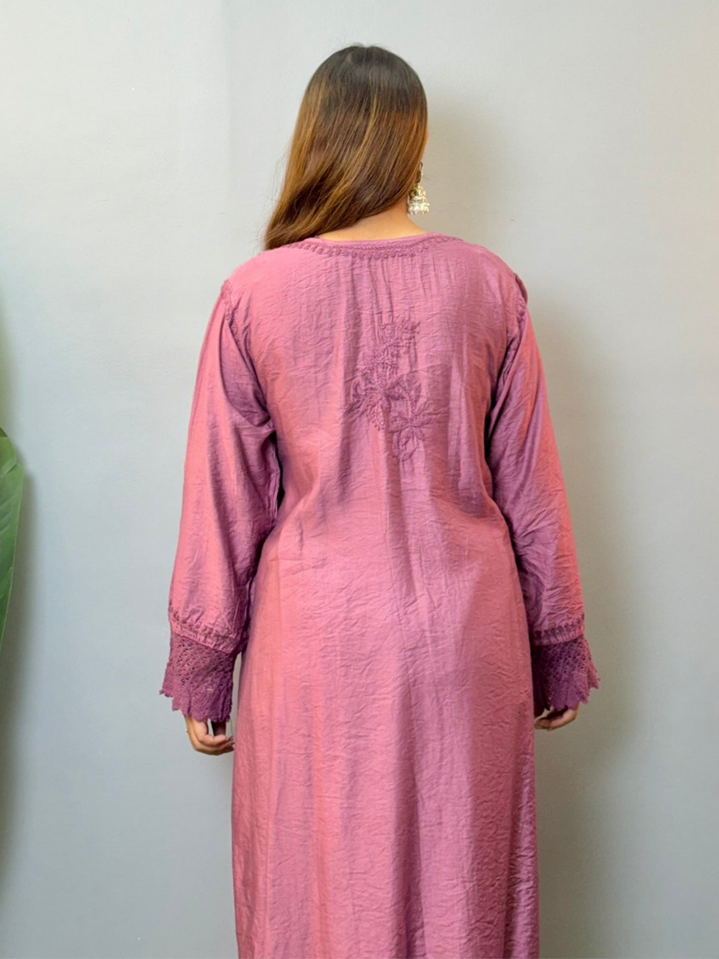 Woman wearing a plum Chanderi Chikankari kurta with hand embroidery and lace detailing, styled with white palazzo pants