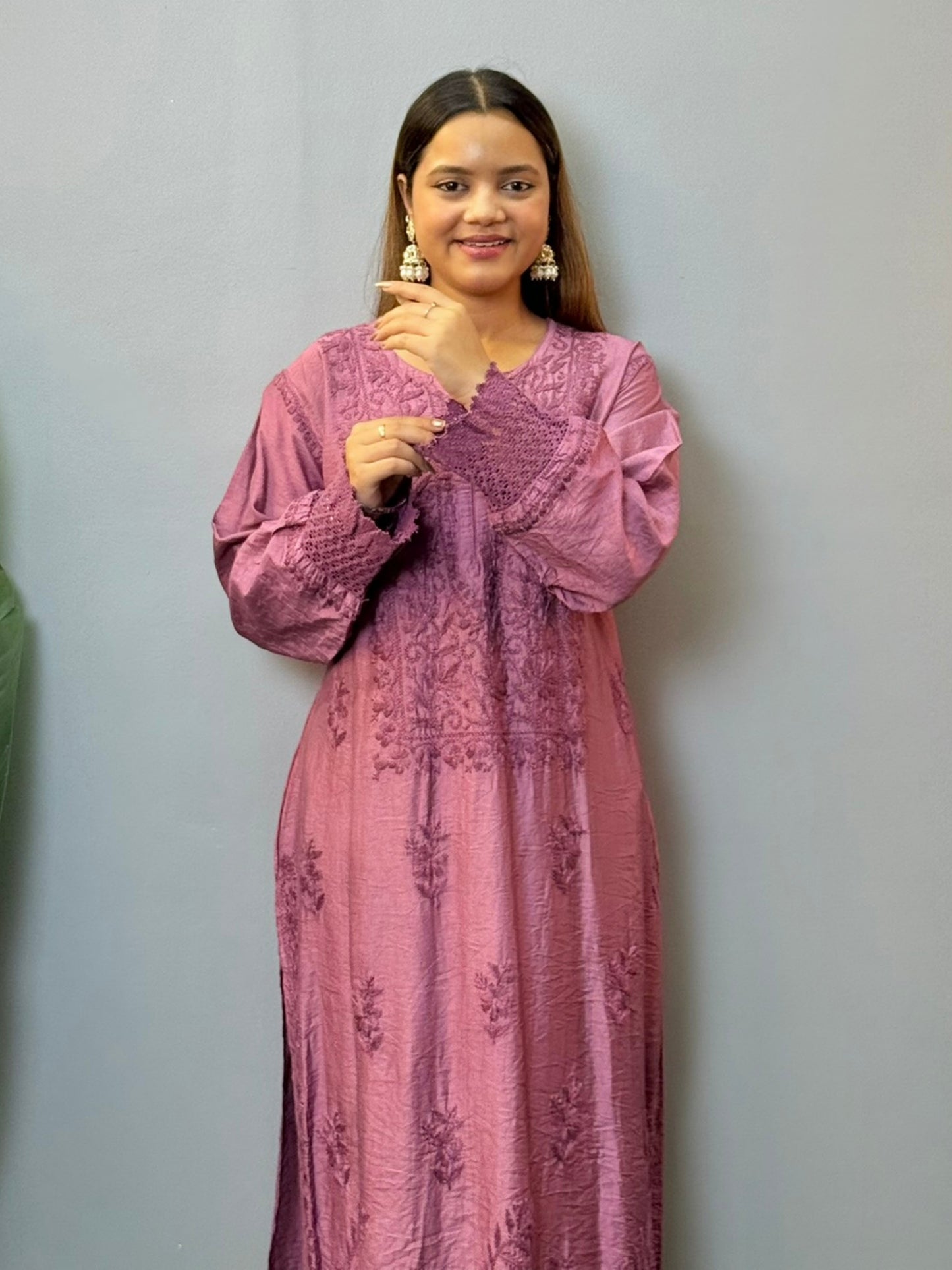 Woman wearing a plum Chanderi Chikankari kurta with hand embroidery and lace detailing, styled with white palazzo pants