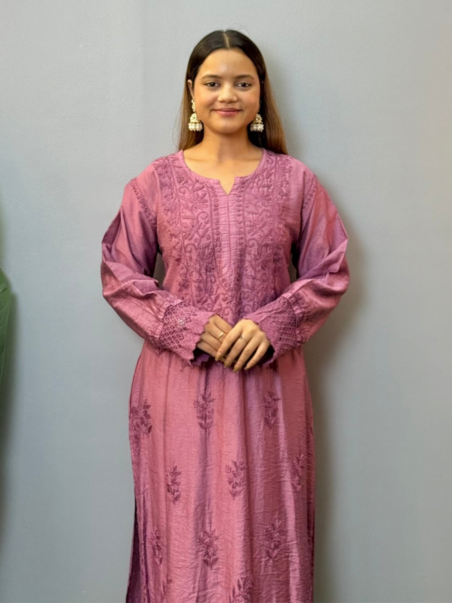 Woman wearing a plum Chanderi Chikankari kurta with hand embroidery and lace detailing, styled with white palazzo pants