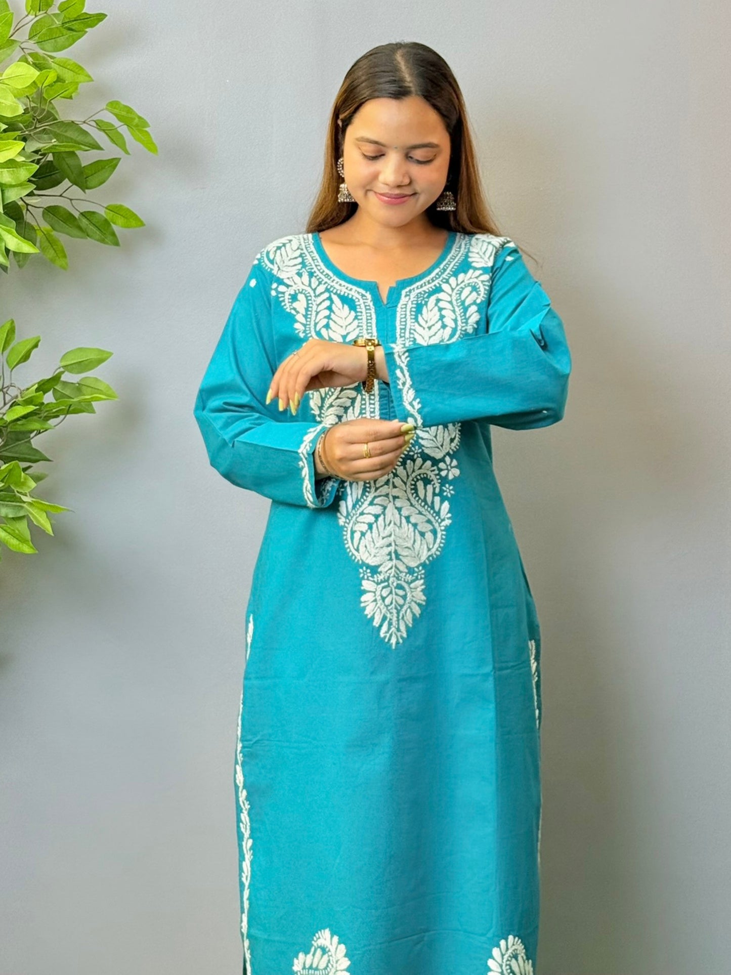 Model in teal blue cotton Chikankari kurta with white thread embroidery