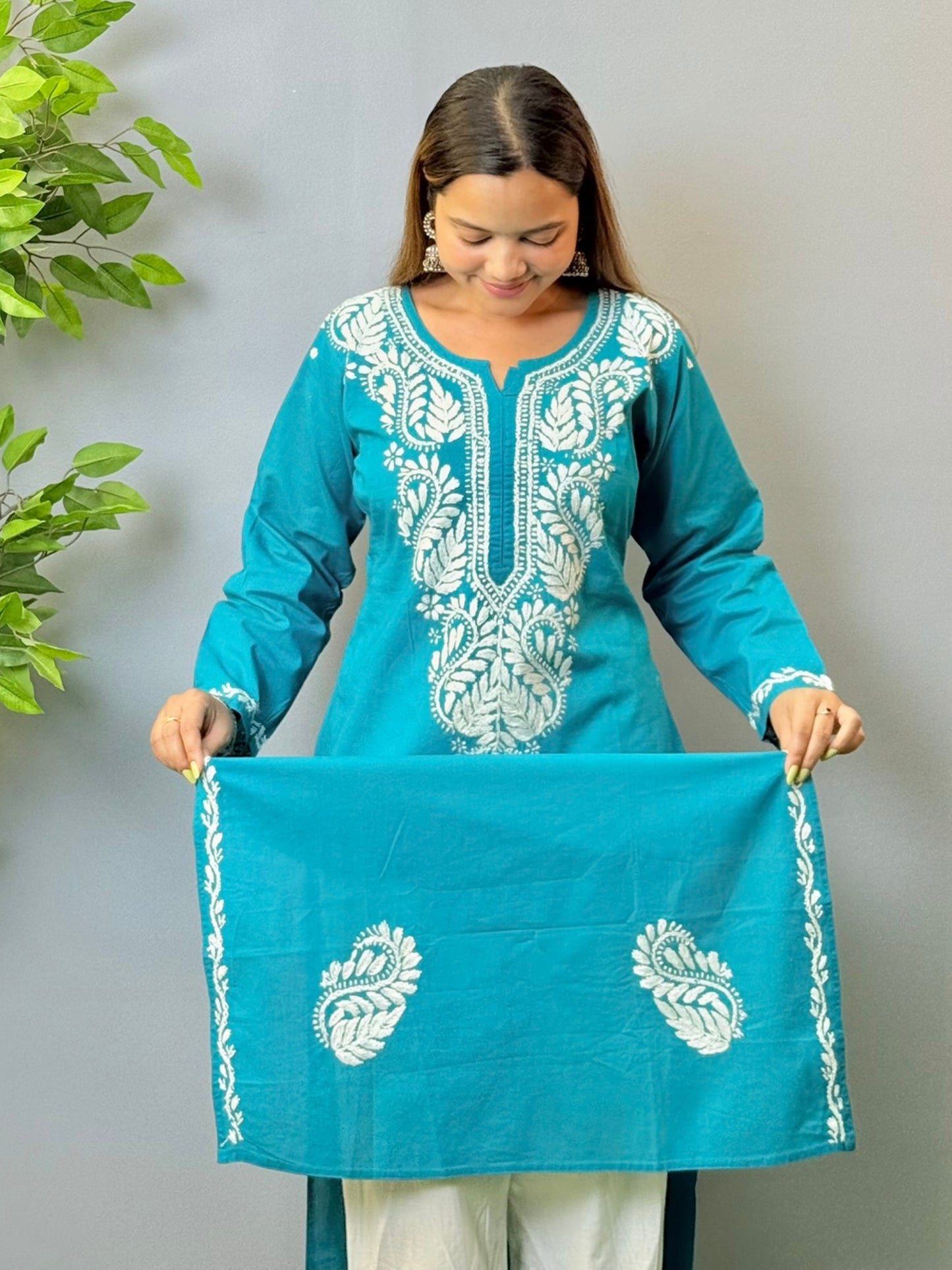 Model in teal blue cotton Chikankari kurta with white thread embroidery