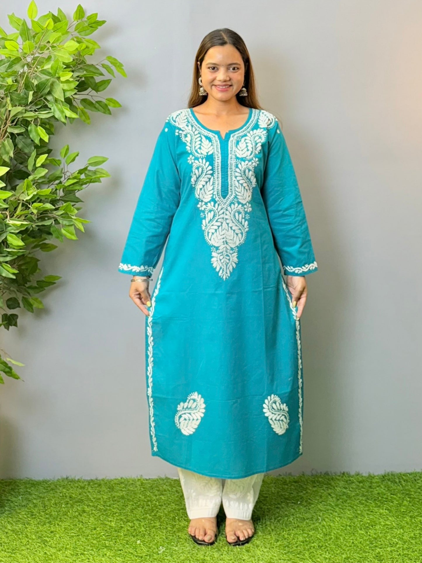 Model in teal blue cotton Chikankari kurta with white thread embroidery