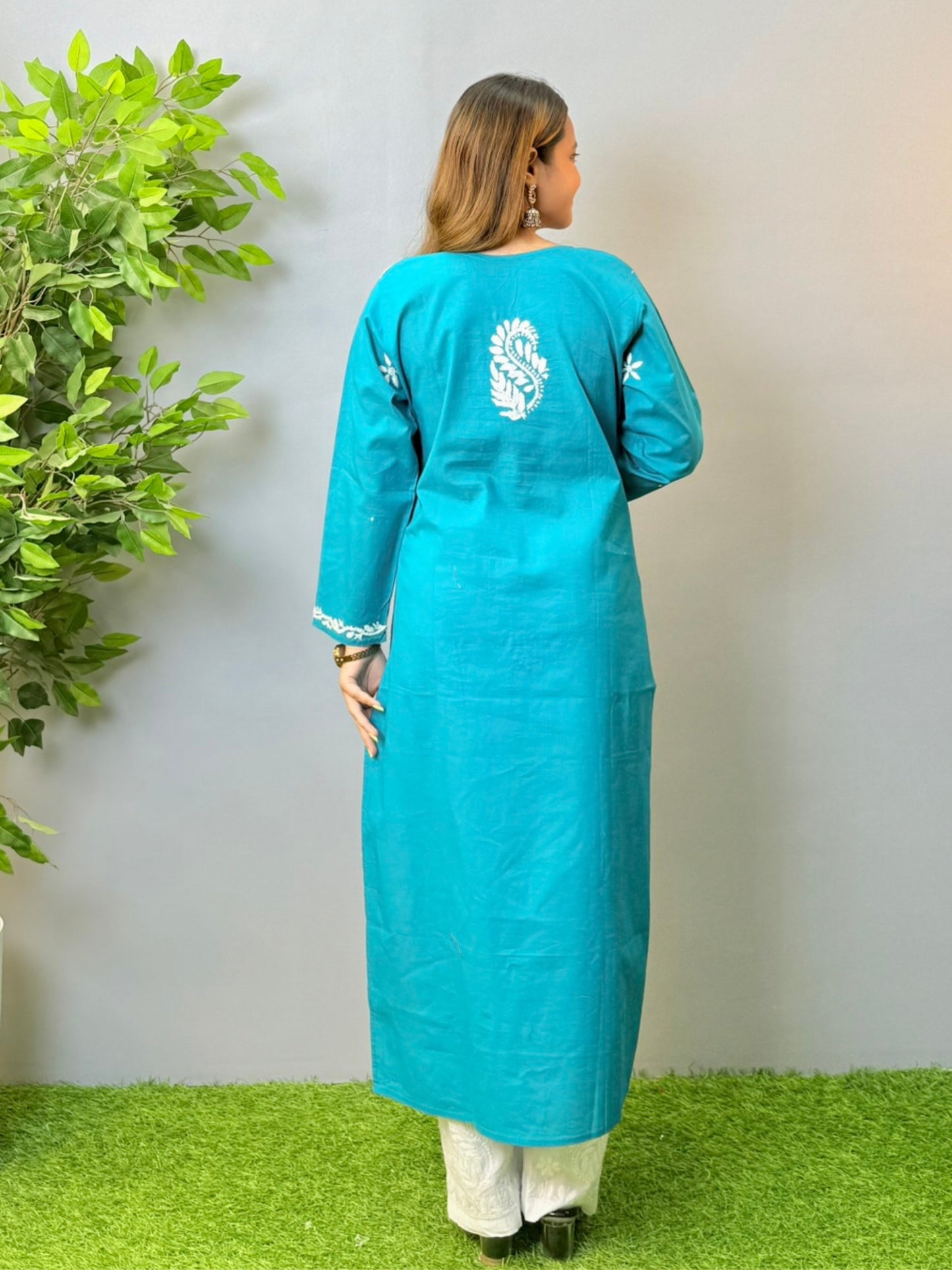 Model in teal blue cotton Chikankari kurta with white thread embroidery