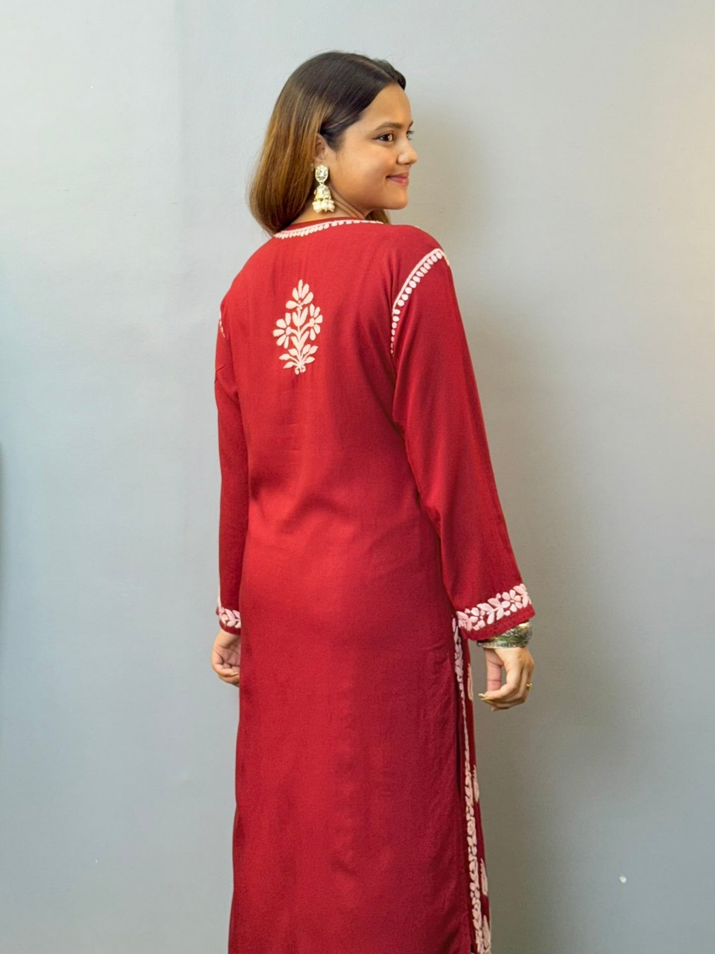 Woman wearing maroon rayon chikankari kurta with white hand embroidery, styled with white palazzo
