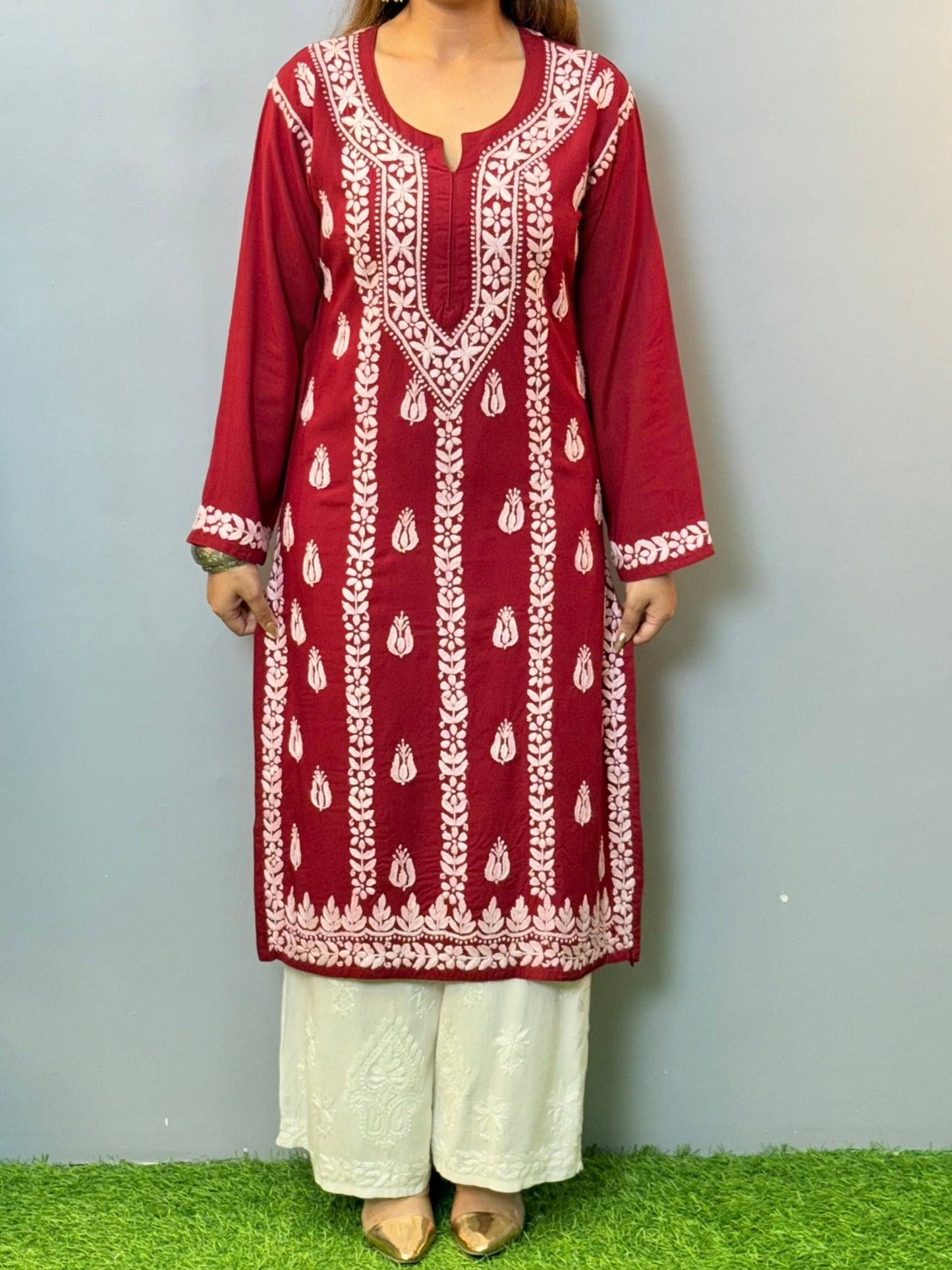 Woman wearing maroon rayon chikankari kurta with white hand embroidery, styled with white palazzo