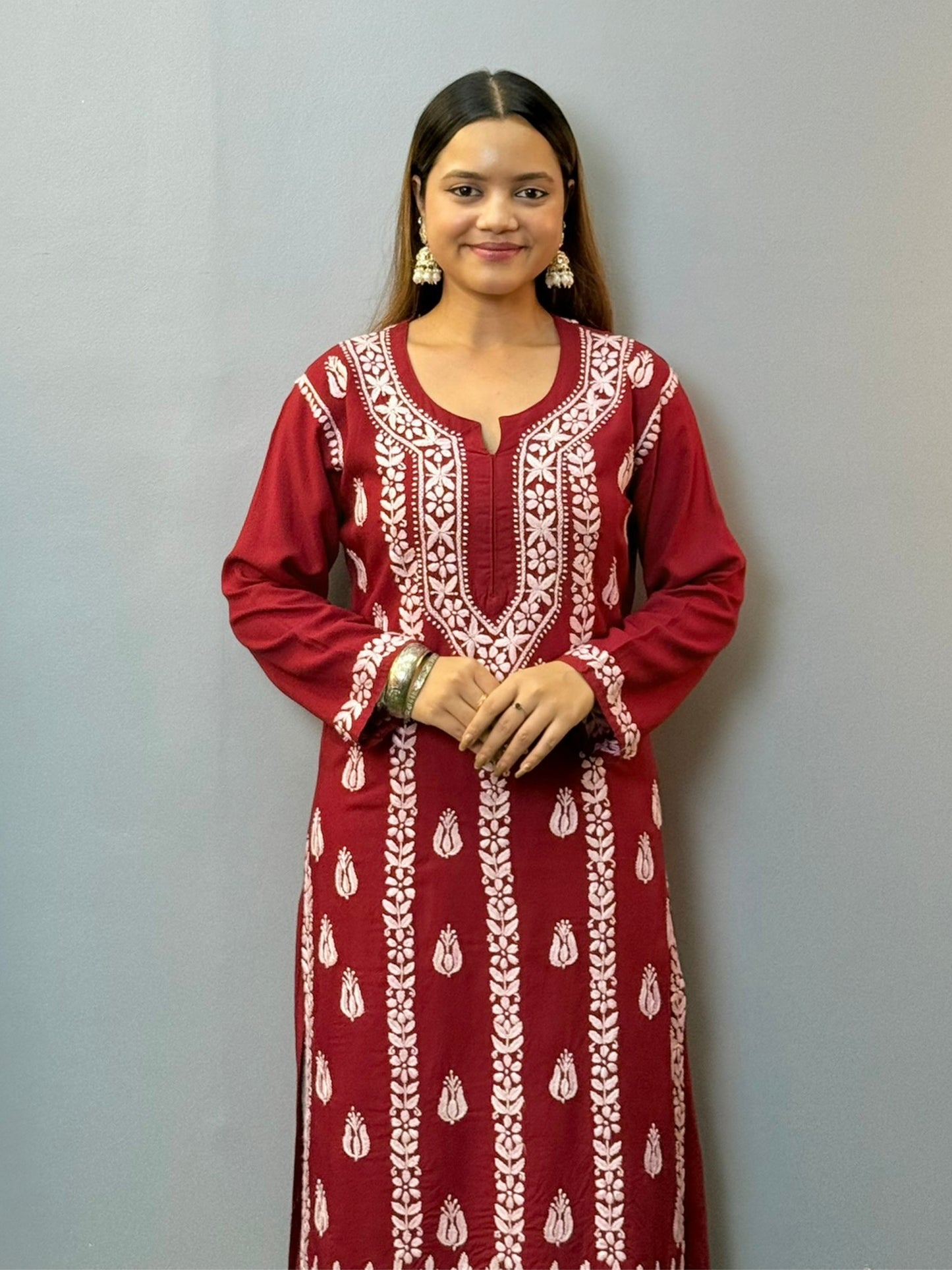 Woman wearing maroon rayon chikankari kurta with white hand embroidery, styled with white palazzo