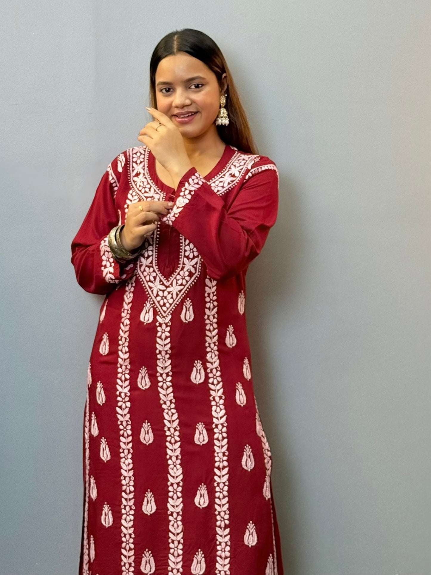 Woman wearing maroon rayon chikankari kurta with white hand embroidery, styled with white palazzo