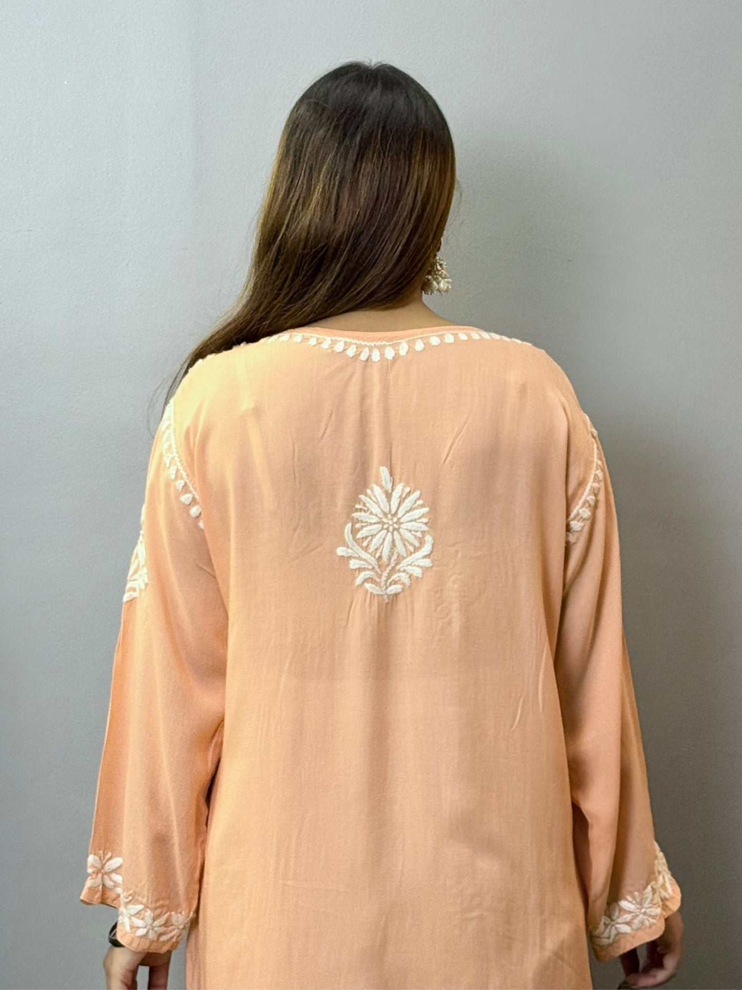 Peach modal kurta featuring intricate white hand Chikankari embroidery