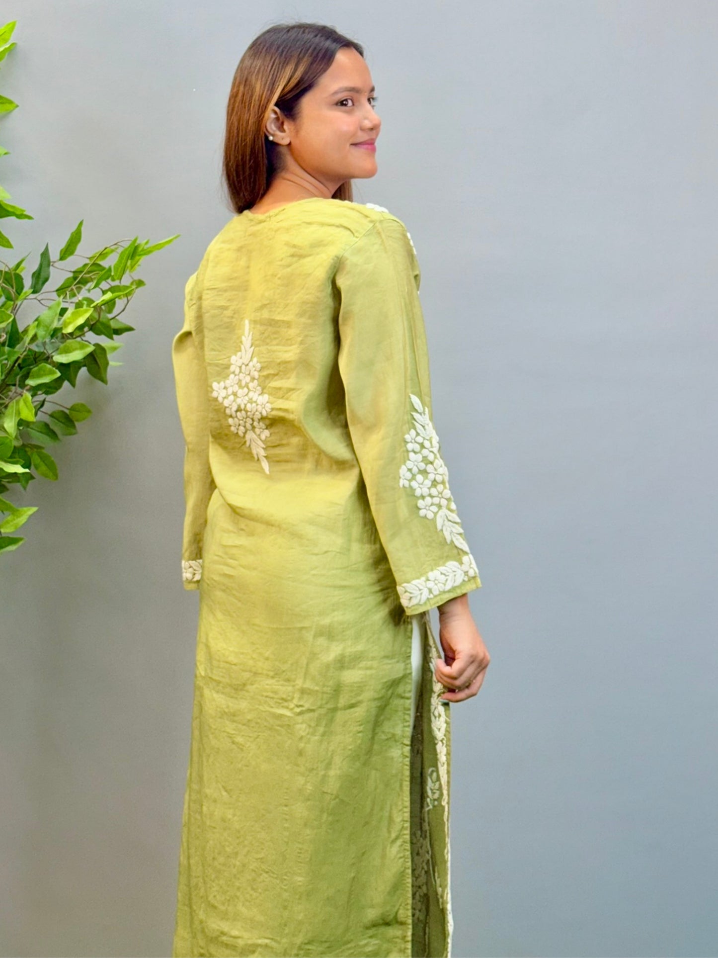 Model wearing ombre olive green chanderi kurta with intricate 3D chikankari floral embroidery.