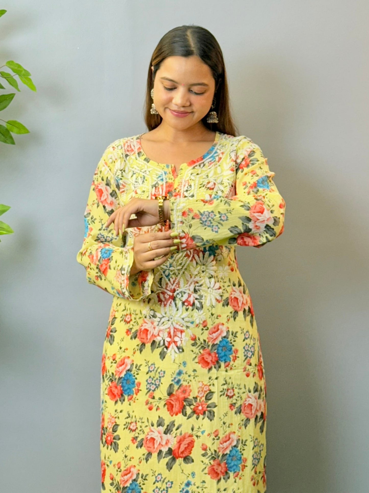 Woman wearing lemon yellow floral printed mulmul chikankari kurta with white embroidery