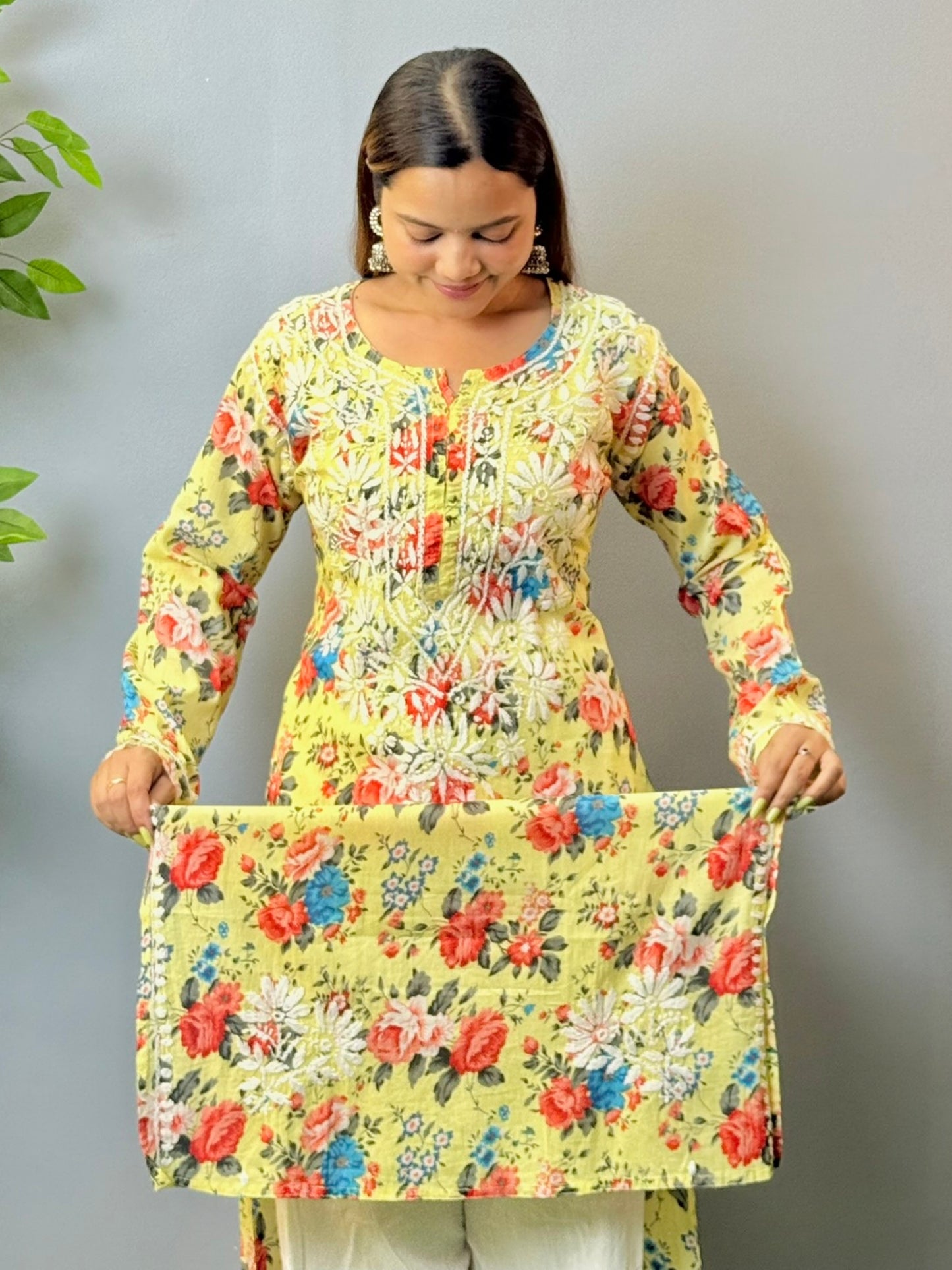 Woman wearing lemon yellow floral printed mulmul chikankari kurta with white embroidery