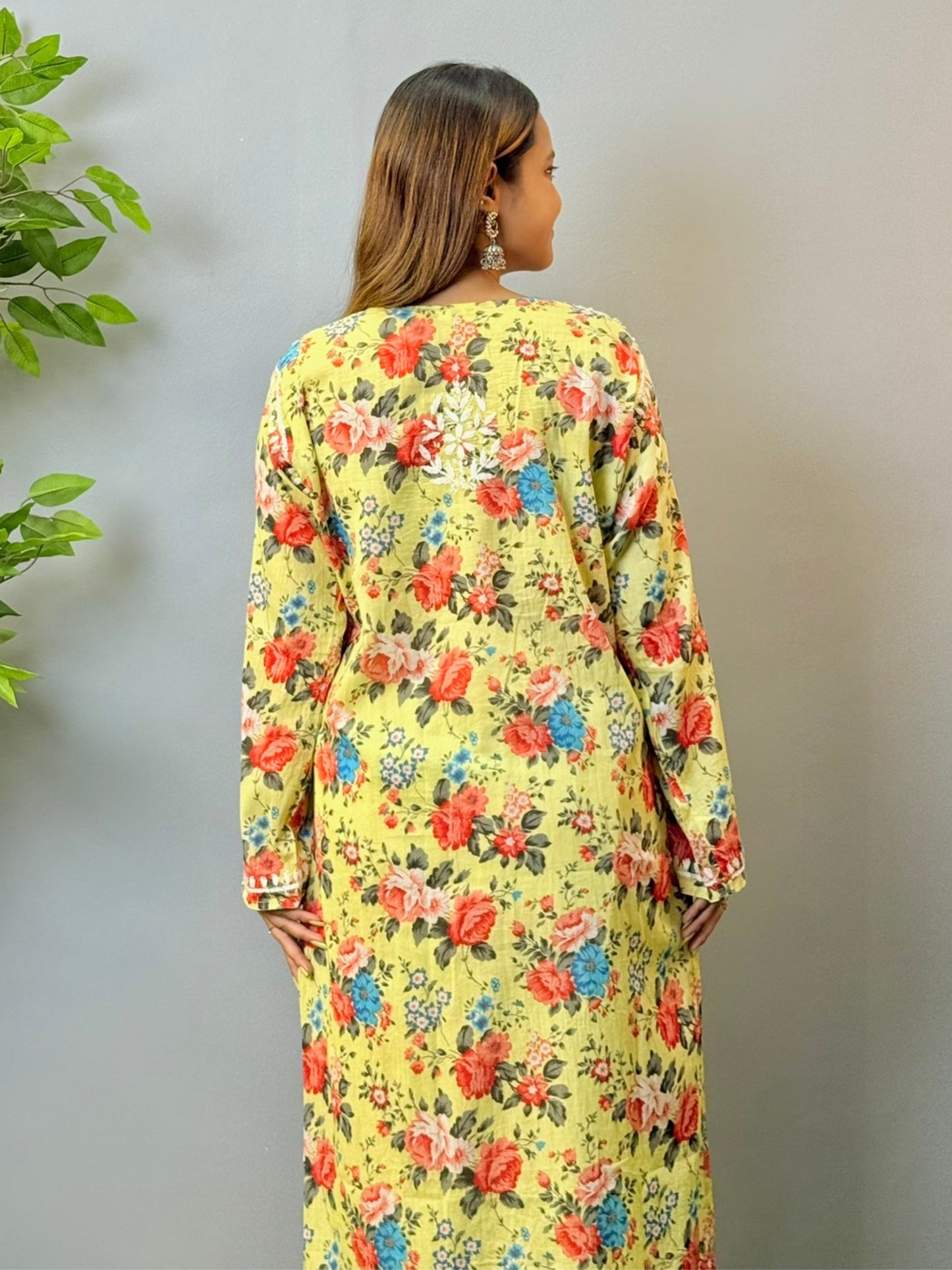 Woman wearing lemon yellow floral printed mulmul chikankari kurta with white embroidery