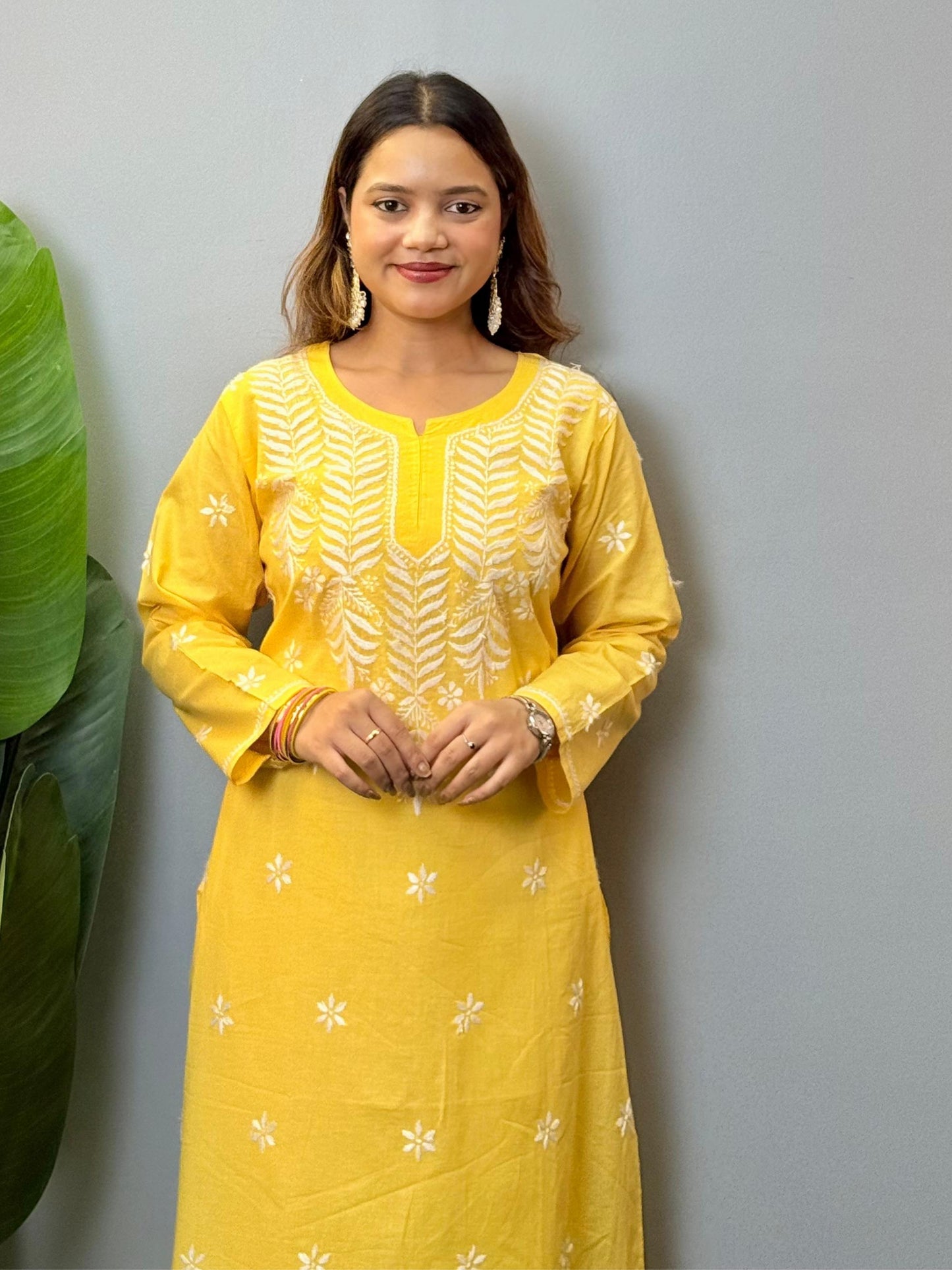 Yellow cotton Lucknow Chikankari kurta with hand embroidery and straight-fit design.