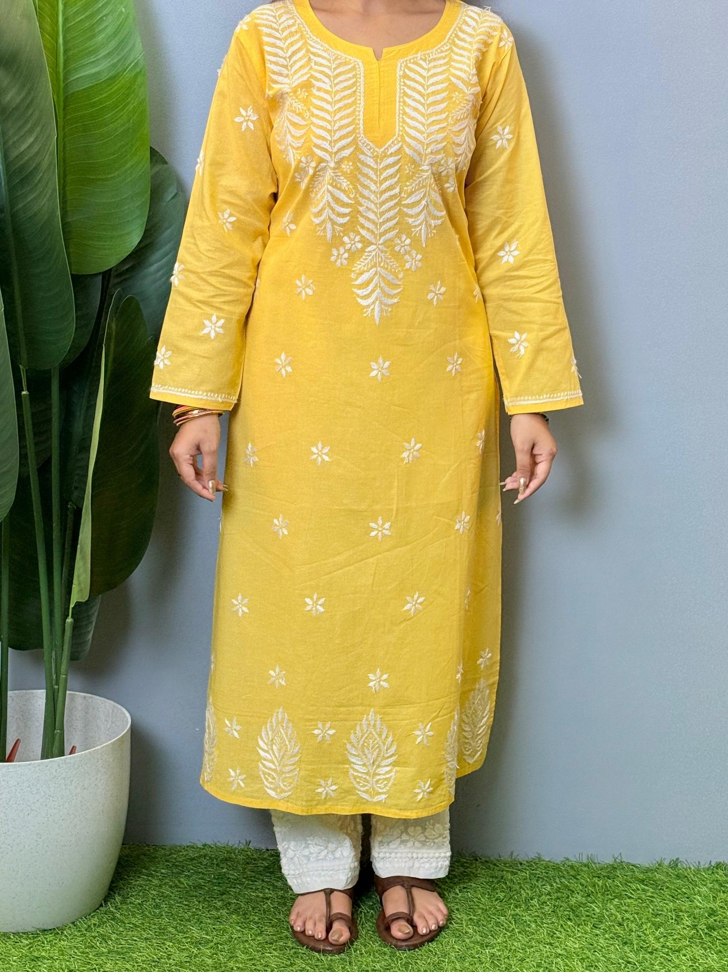 Yellow cotton Lucknow Chikankari kurta with hand embroidery and straight-fit design.