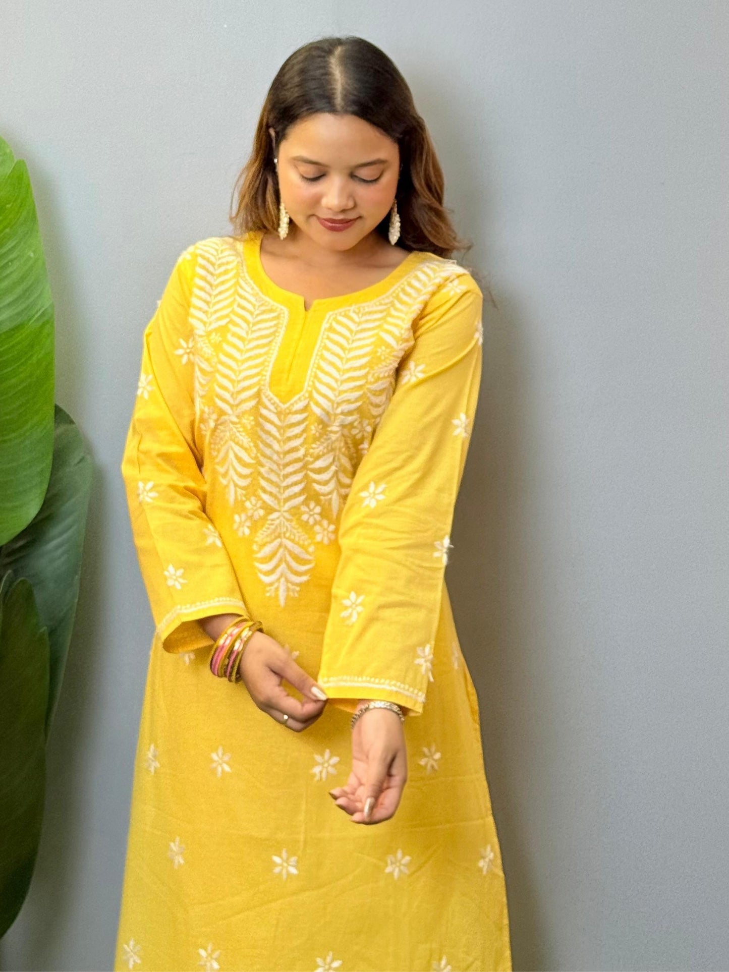 Yellow cotton Lucknow Chikankari kurta with hand embroidery and straight-fit design.