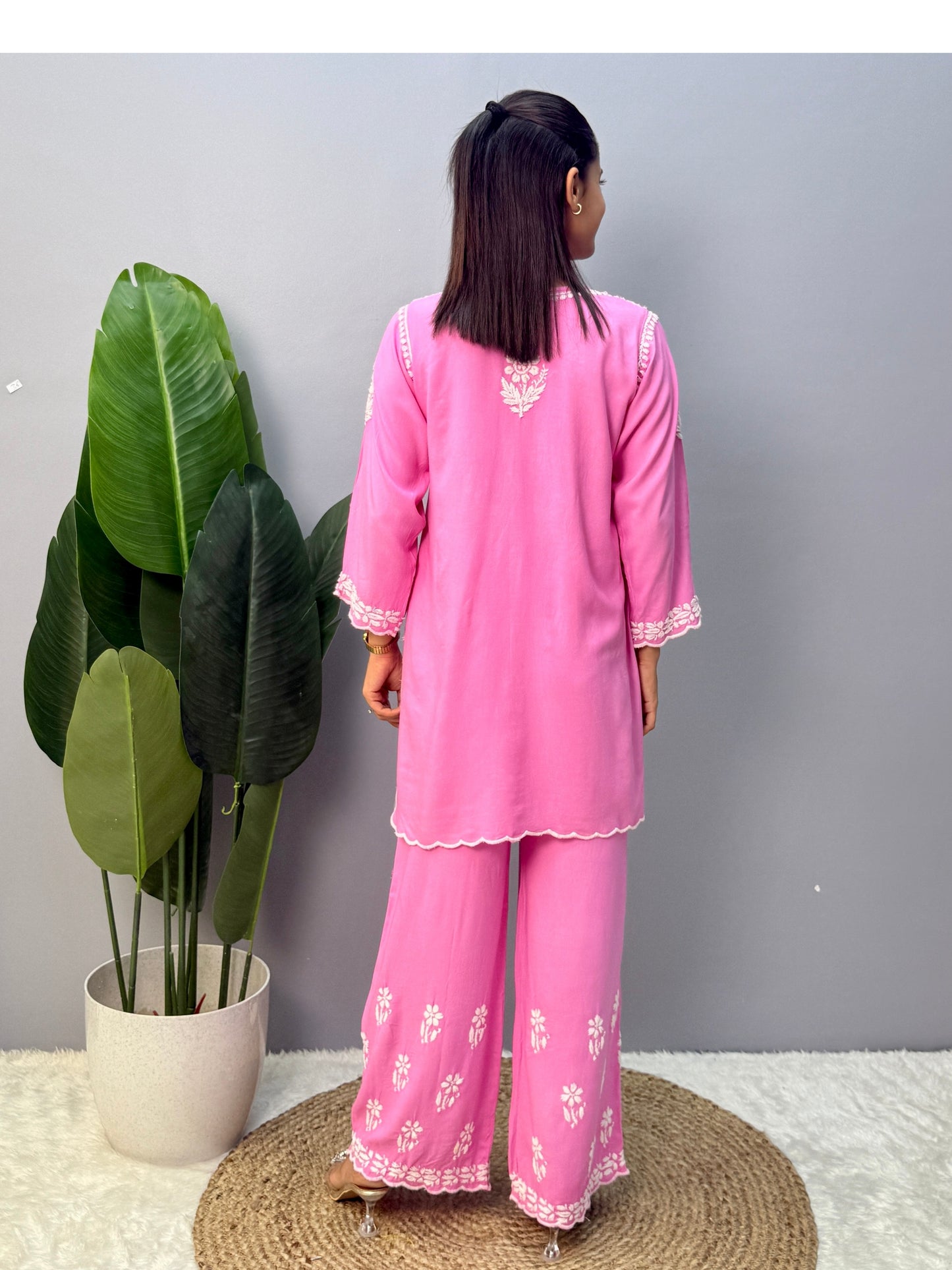Pink rayon short kurta with palazzo pant featuring white hand-embroidered Lucknow Chikankari design.