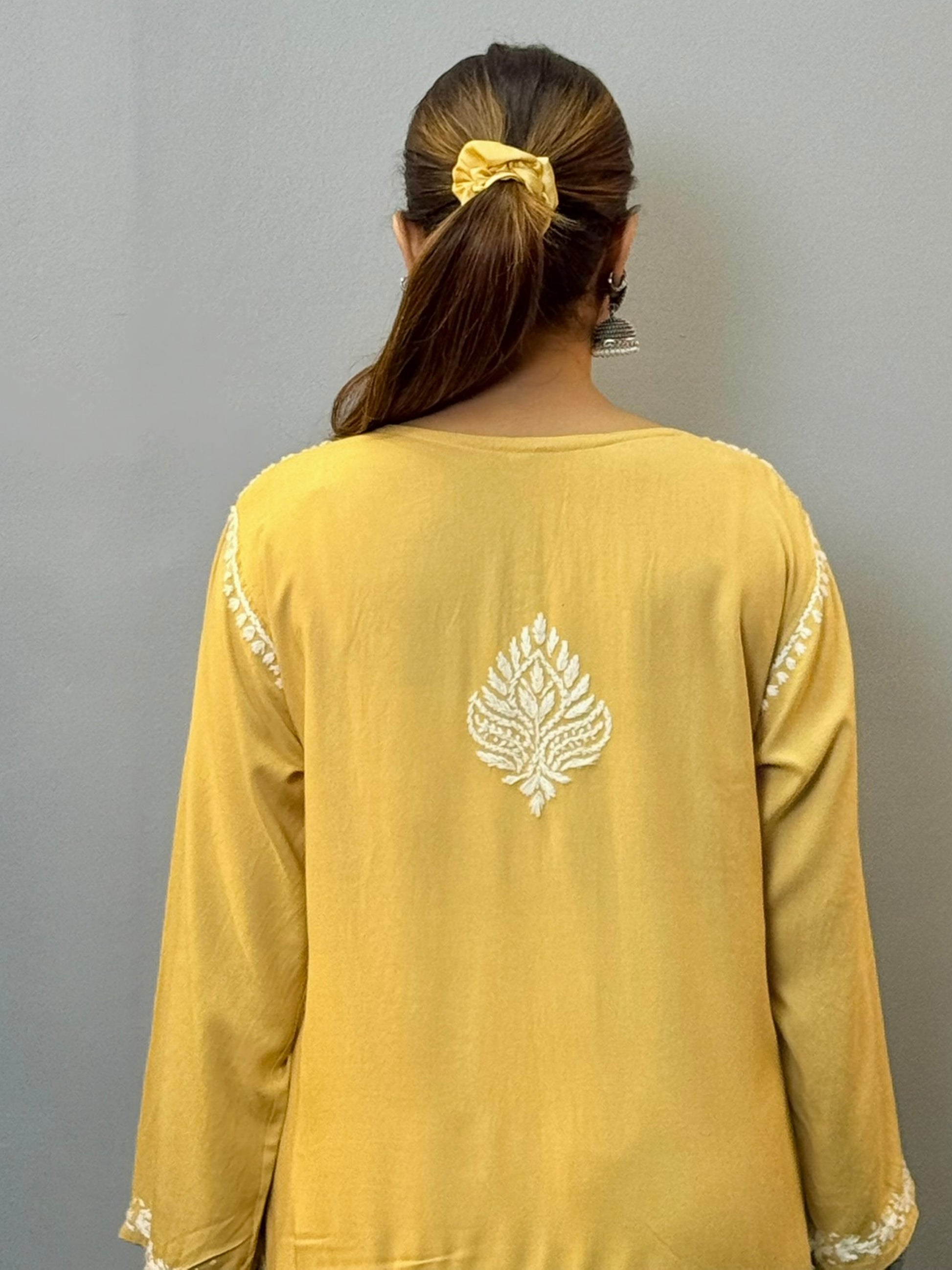 Woman wearing mustard yellow rayon kurta with white hand-embroidered Lucknowi Chikankari