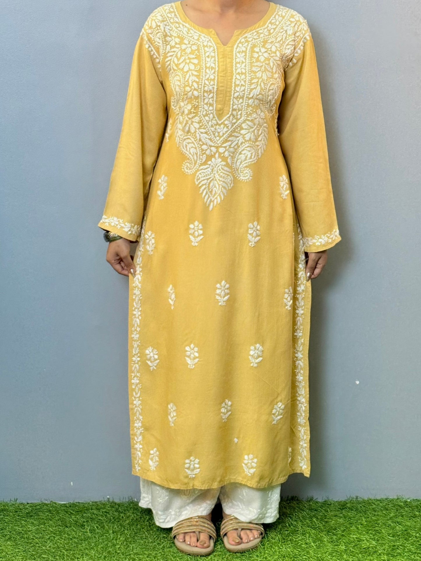 Woman wearing mustard yellow rayon kurta with white hand-embroidered Lucknowi Chikankari