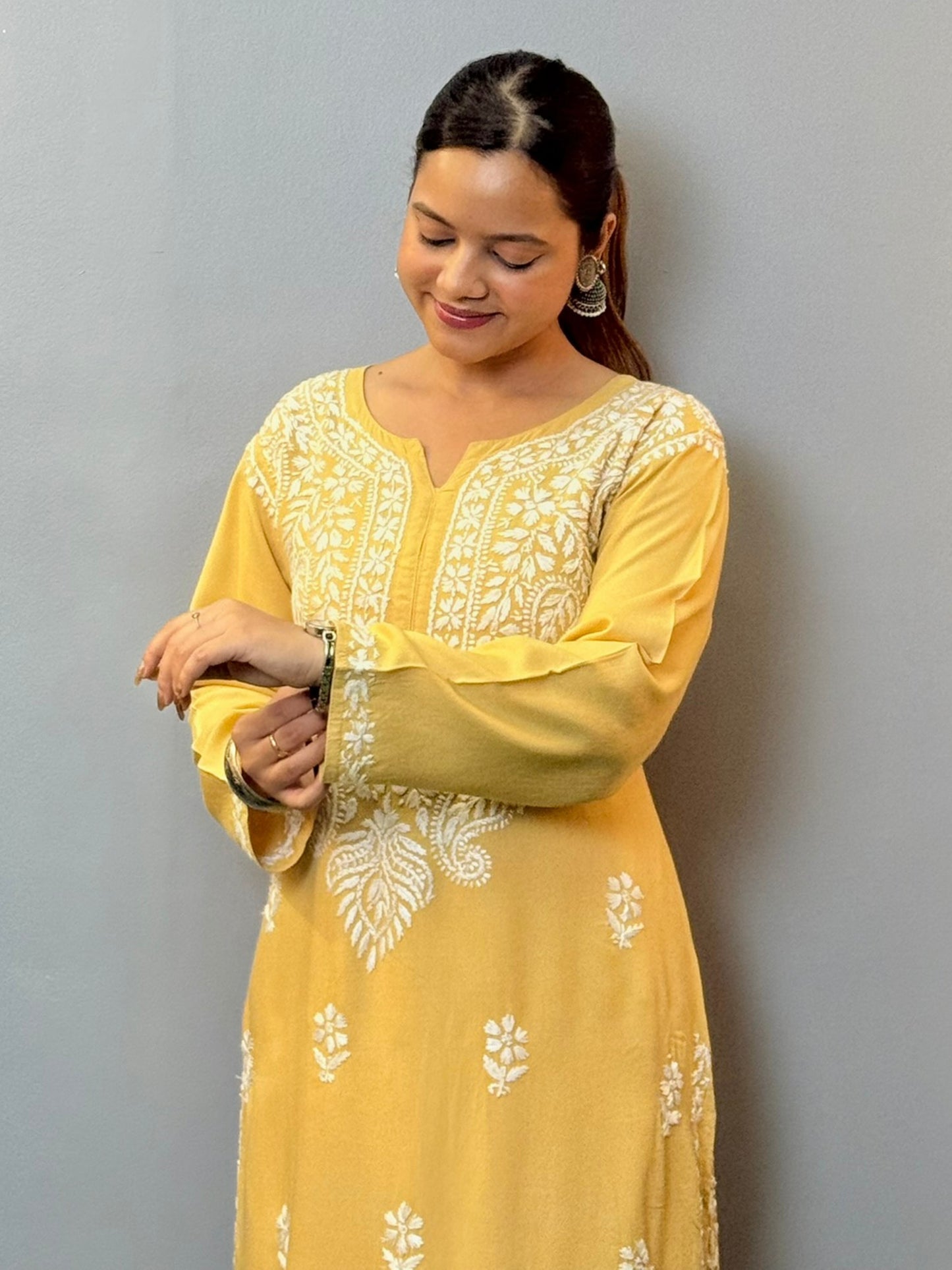Woman wearing mustard yellow rayon kurta with white hand-embroidered Lucknowi Chikankari