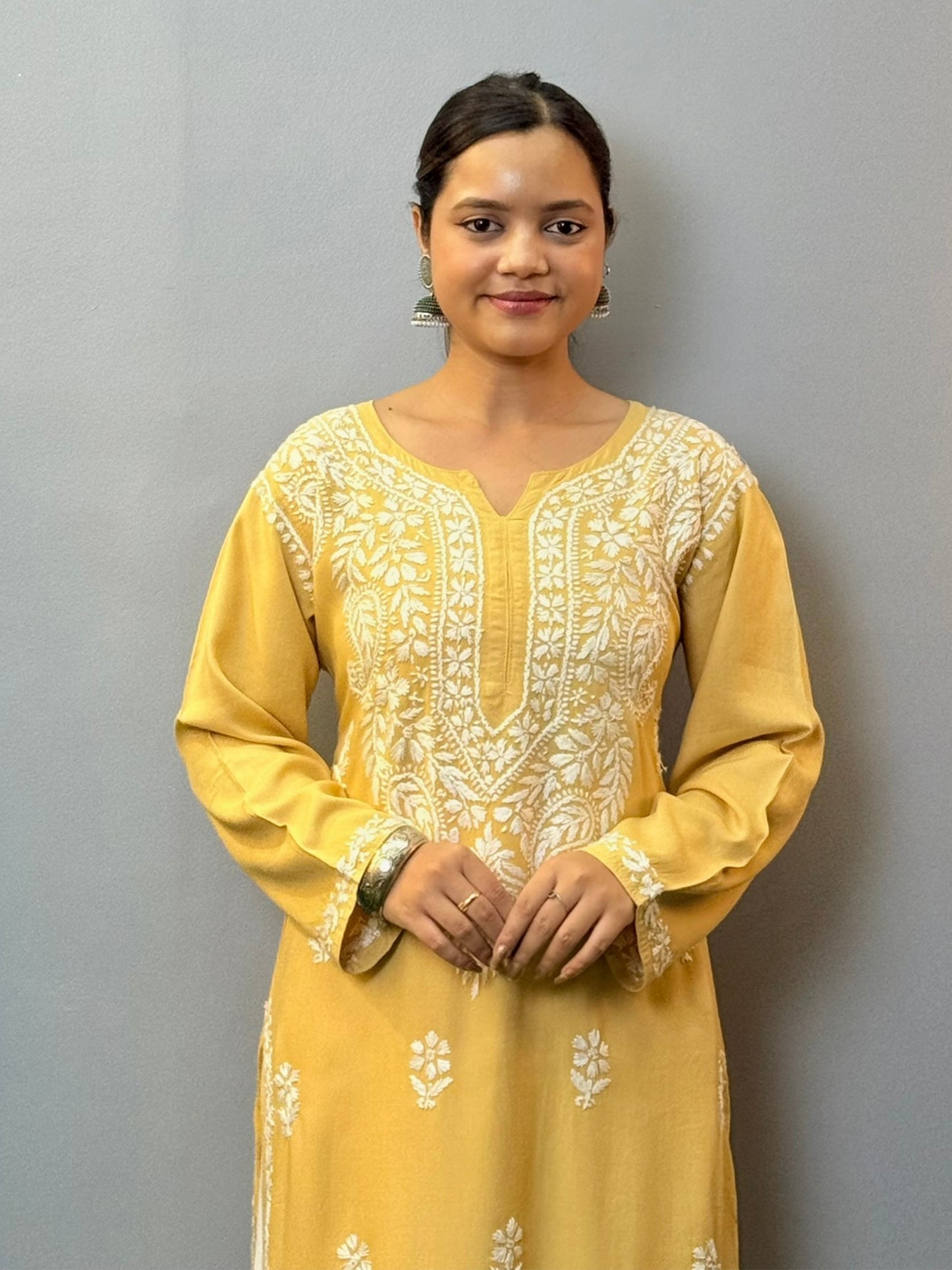 Woman wearing mustard yellow rayon kurta with white hand-embroidered Lucknowi Chikankari