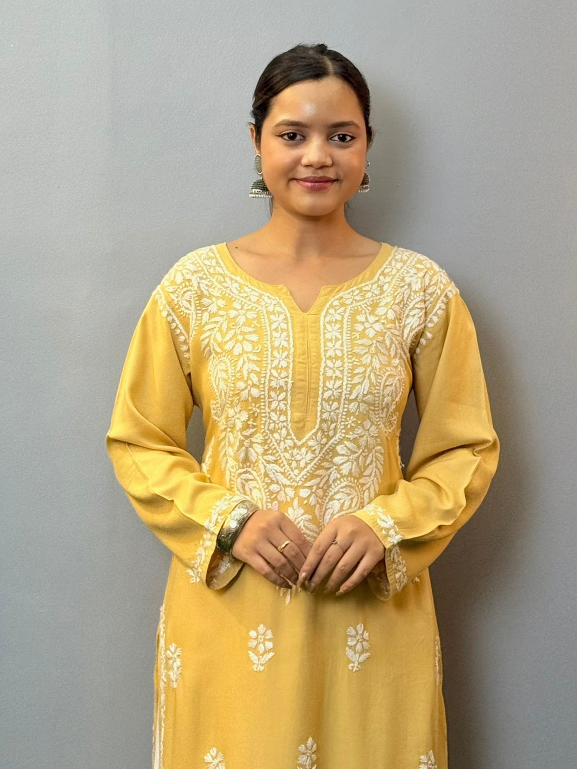 Woman wearing mustard yellow rayon kurta with white hand-embroidered Lucknowi Chikankari