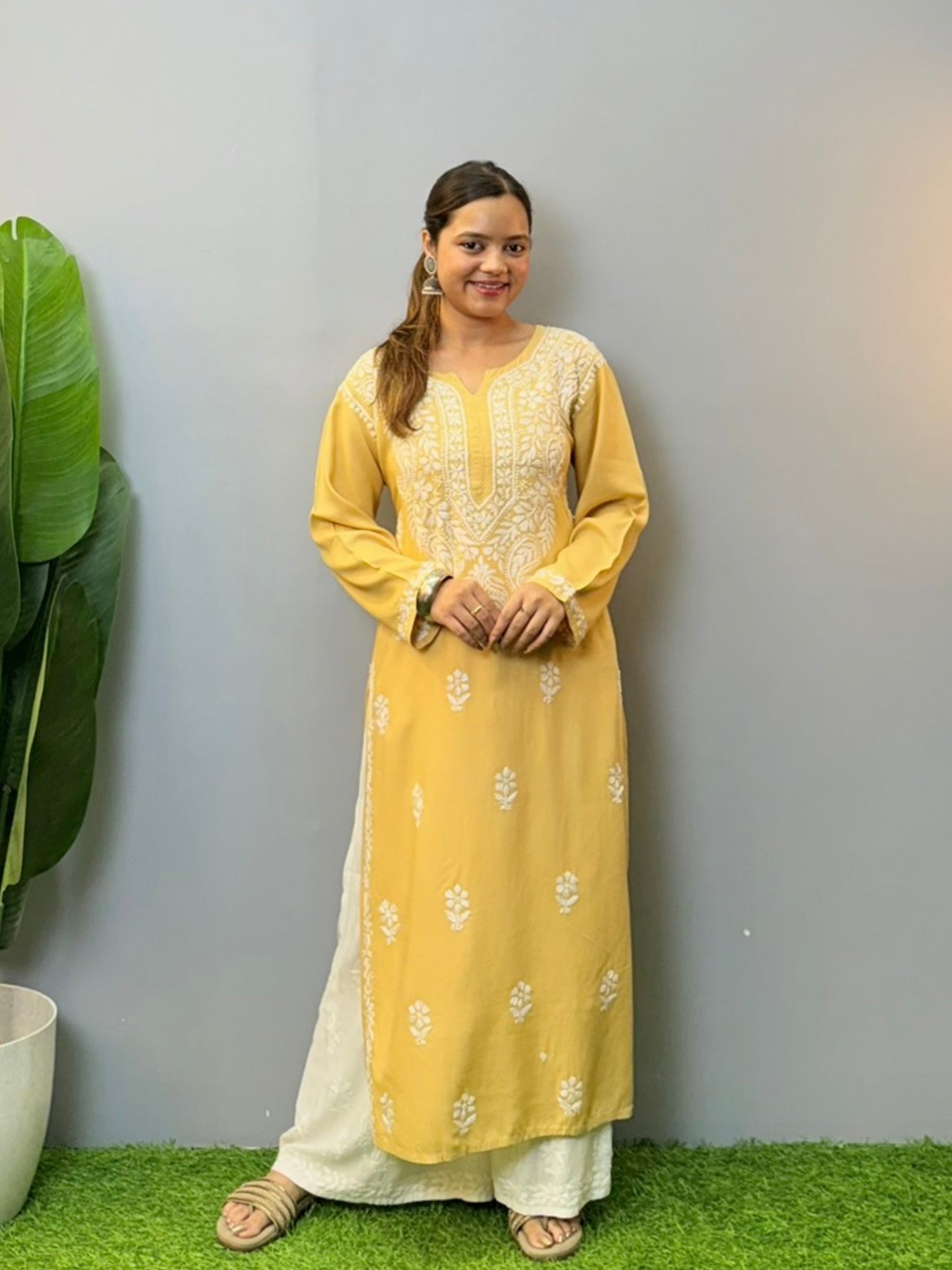 Woman wearing mustard yellow rayon kurta with white hand-embroidered Lucknowi Chikankari